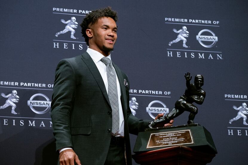 Oklahoma quarterback Kyler Murray holds the Heisman Trophy after winning the award Saturday,...