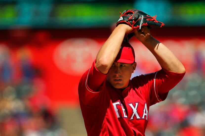 Texas Rangers starting pitcher Derek Holland (45) starts his windup as he throws against the...