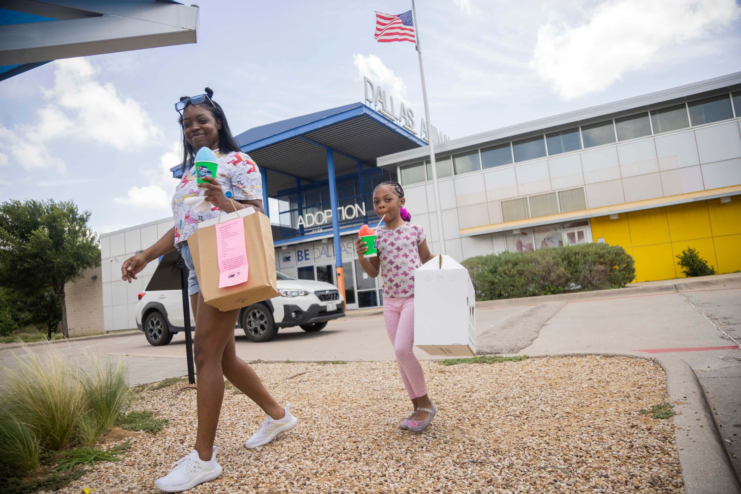 Skylar Offor of Arlington and daughter Makenzie Williams, 6, walk back to their car after...
