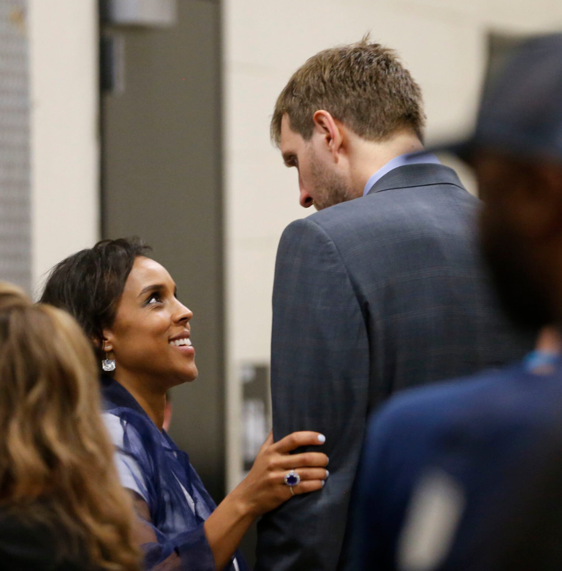 Dallas Mavericks forward Dirk Nowitzki (41) talks with his wife Jessica Nowitzki after his...