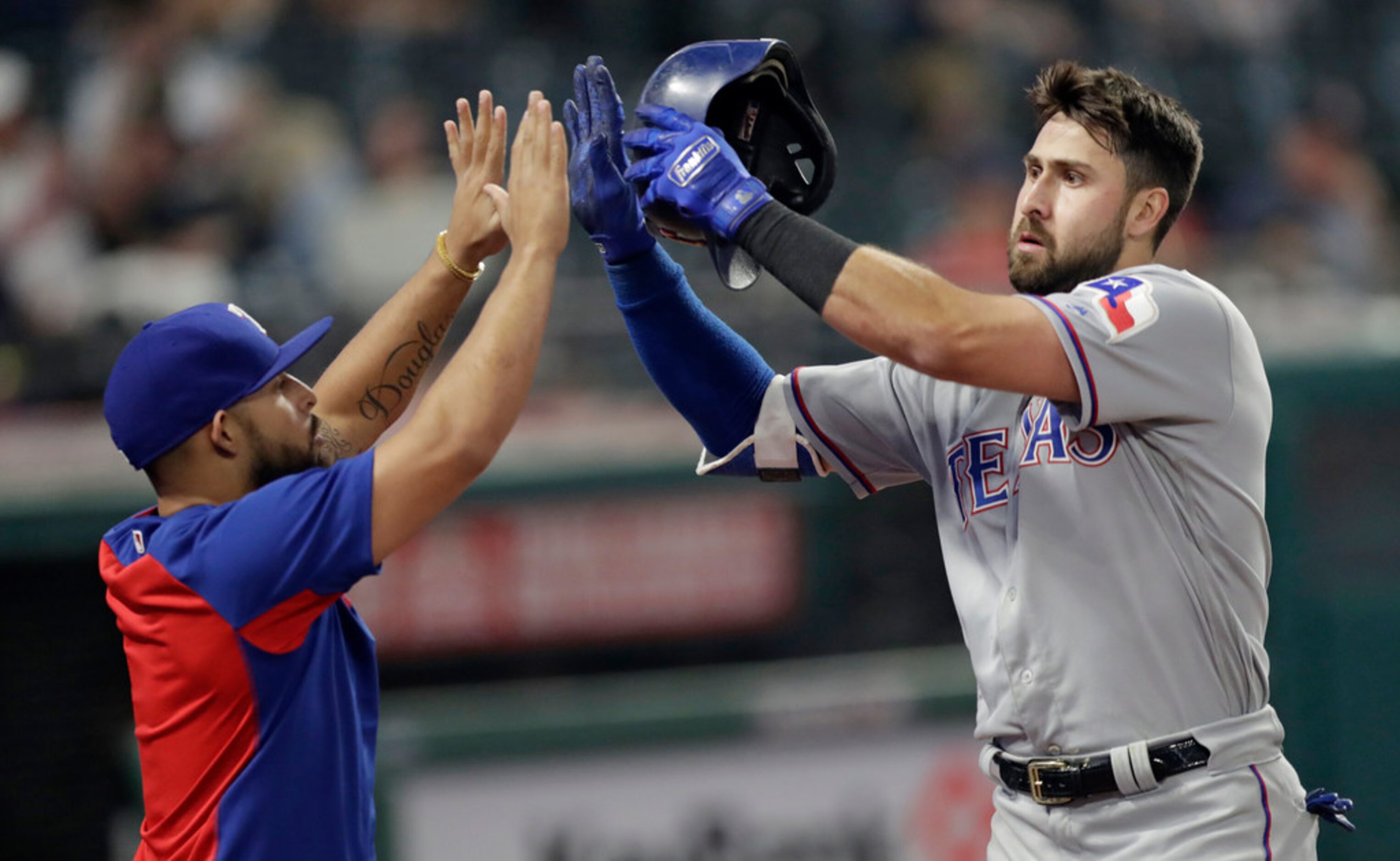 Texas Rangers' Rougned Odor, left congratulates Joey Gallo after Gallo hit a solo home run...