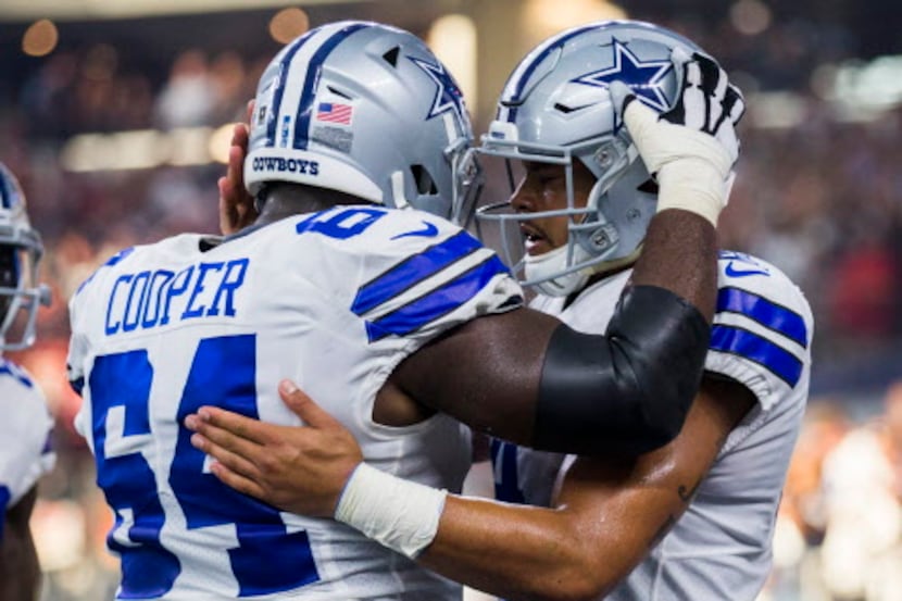 Dallas Cowboys quarterback Dak Prescott (4) celebrates a touchdown with offensive guard...