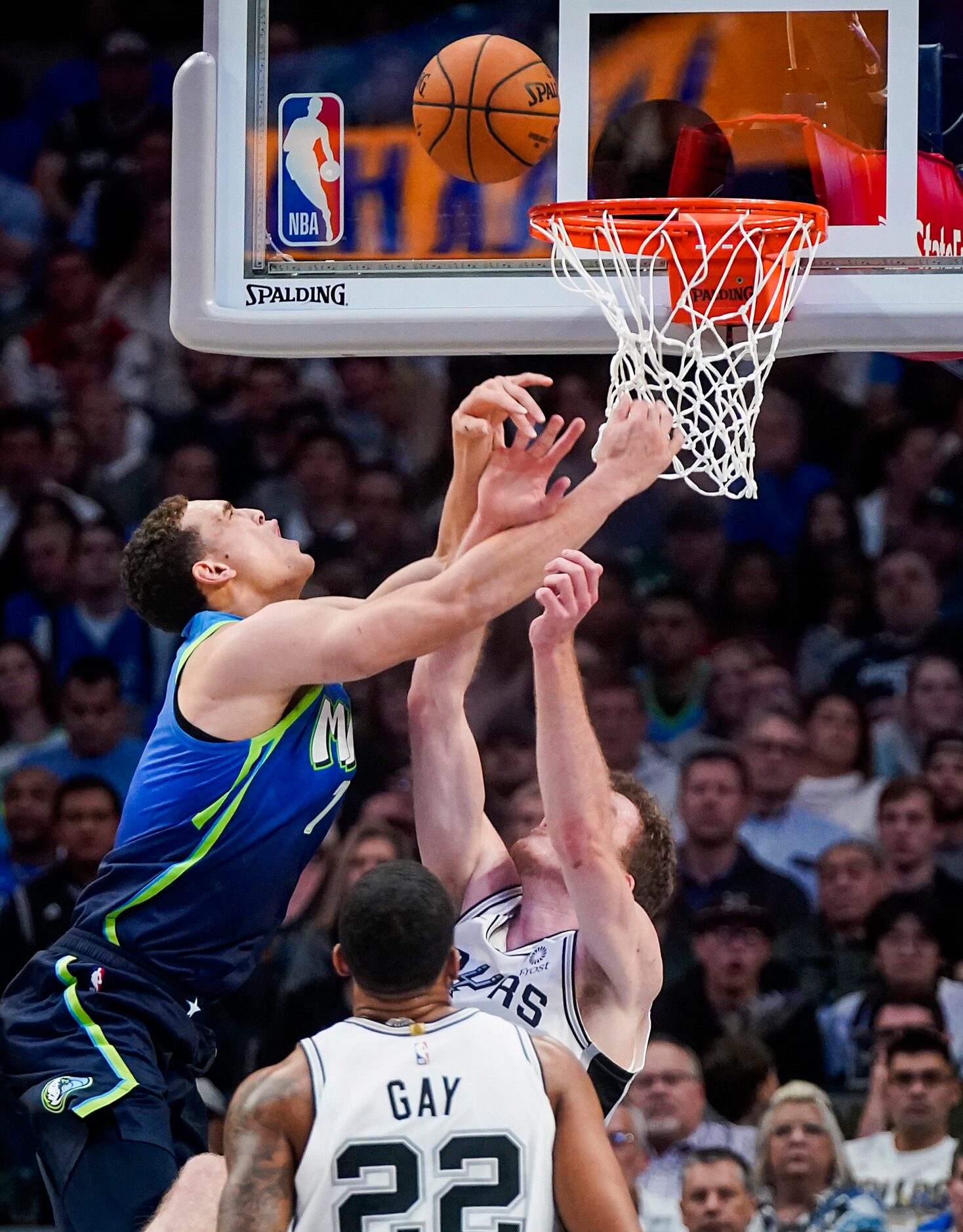 Dallas Mavericks forward Dwight Powell (7) is fouled by San Antonio Spurs center Jakob...