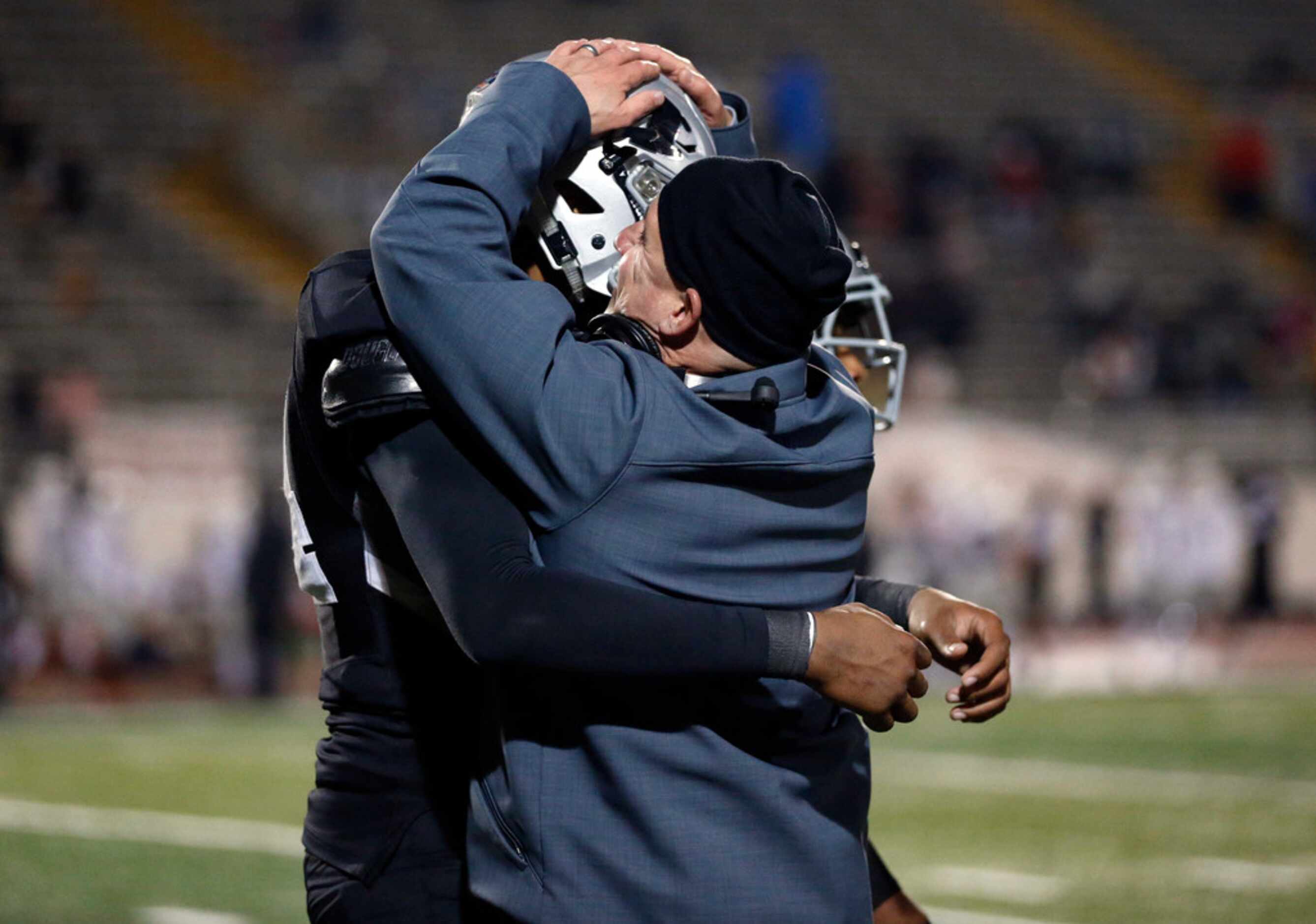Martin head coach Bob Wager gives his defensive lineman Ernest Cooper IV a big hug after he...