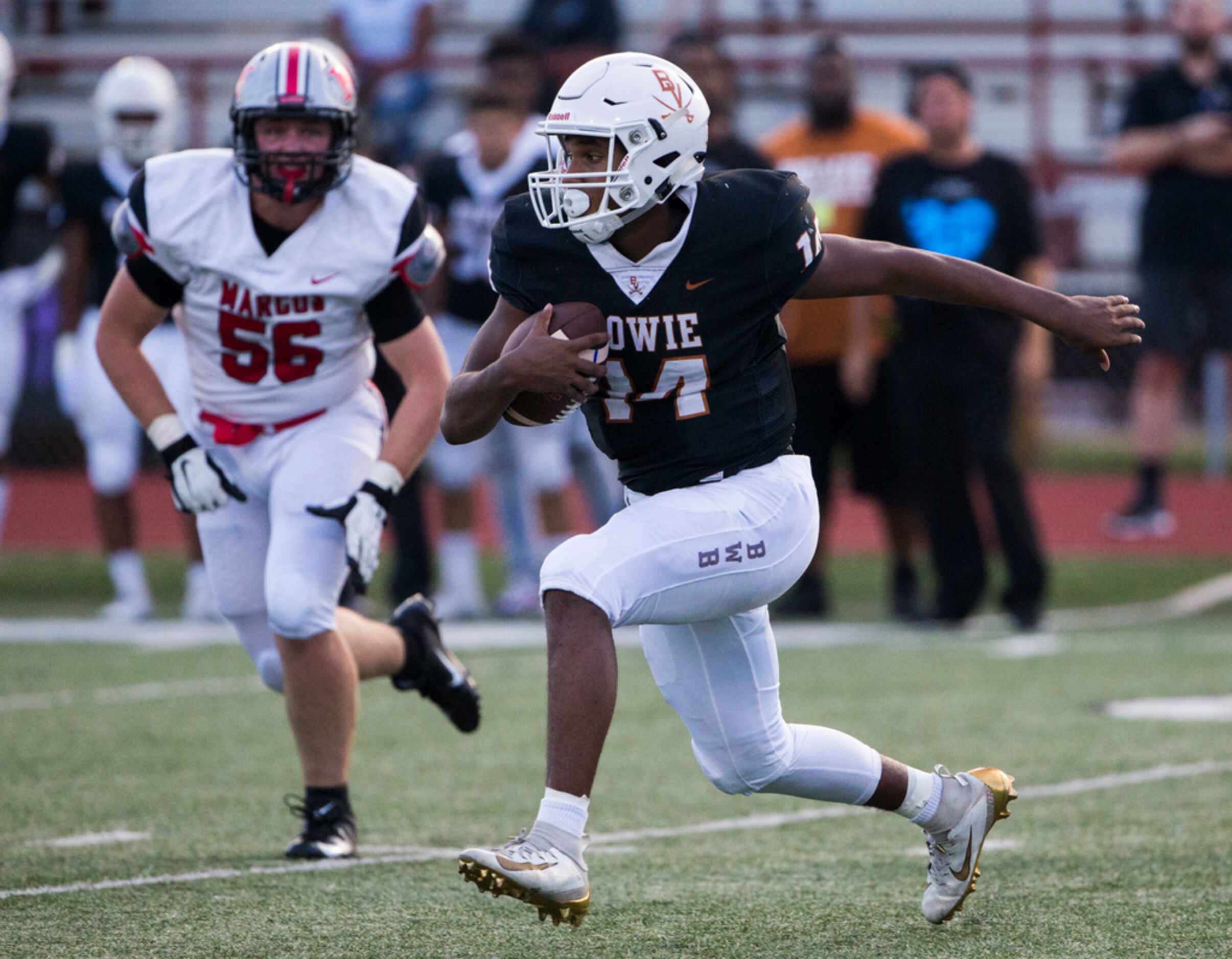 Arlington Bowie quarterback Drevvon Ponder (14) runs the ball ahead of Flower Mound Marcus...