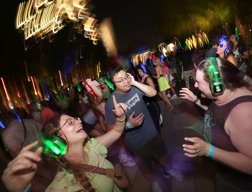 Guests participate in a silent disco at Klyde Warren Park in Dallas on Sept. 6, 2024.