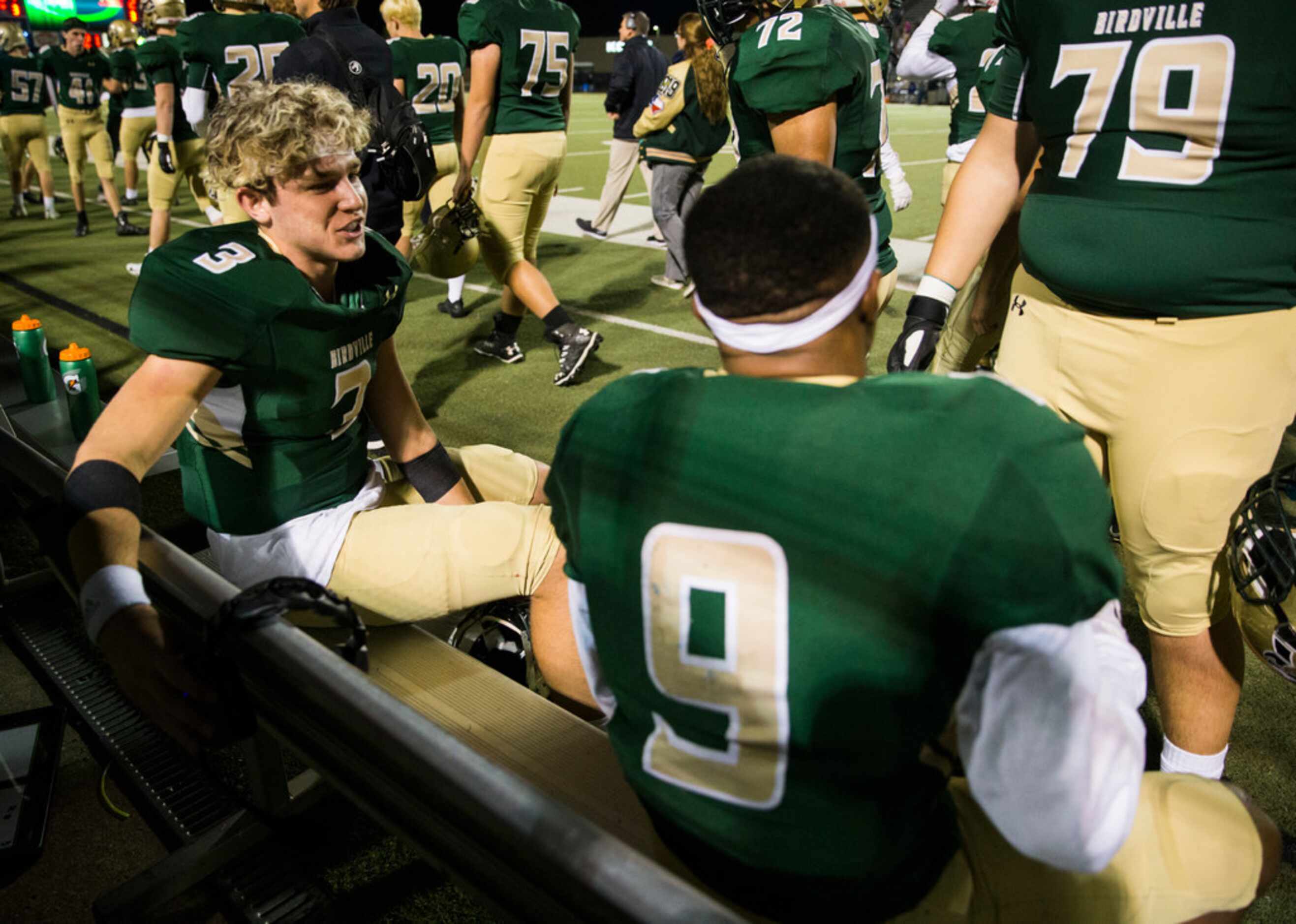 Birdville quarterback Stone Earle (3) talks with running back Laderrious Mixon (9) on the...