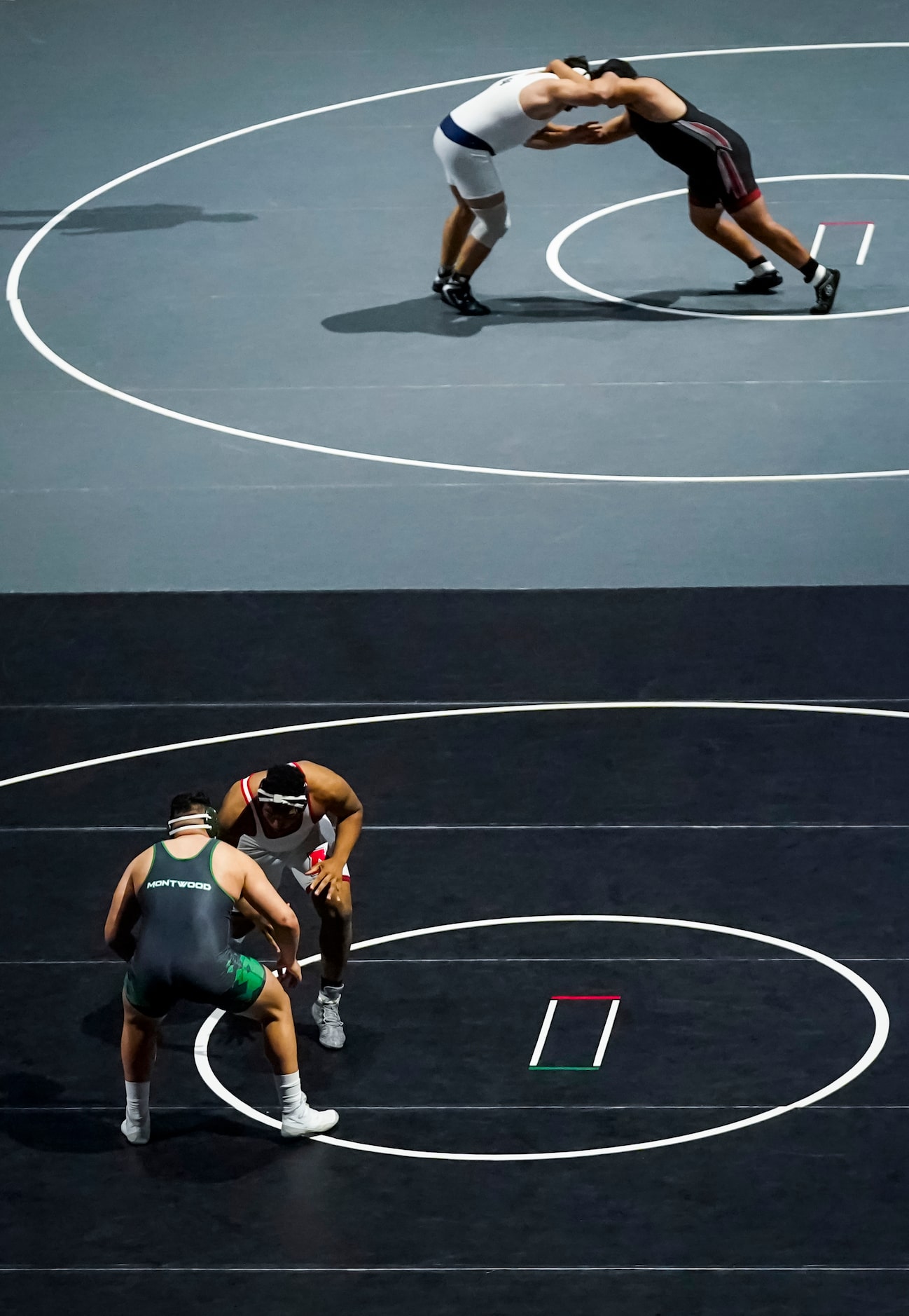 Emmett Bivens of Allen (facing, bottom) wrestles Ivan Escobar of El Paso Montwood for the 6A...