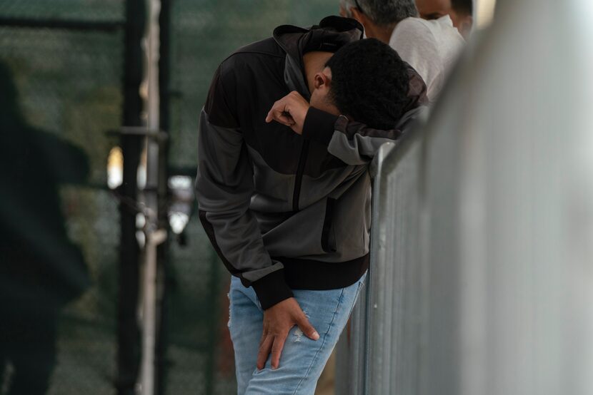 FILE - A migrant waits at the Gateway International Port of Entry under U.S. Customs and...