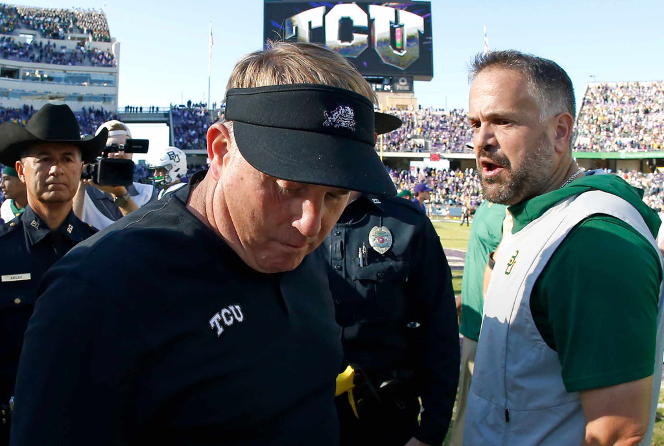 TCU head coach Gary Patterson and Baylor head coach Matt Rhule meet on the field following...