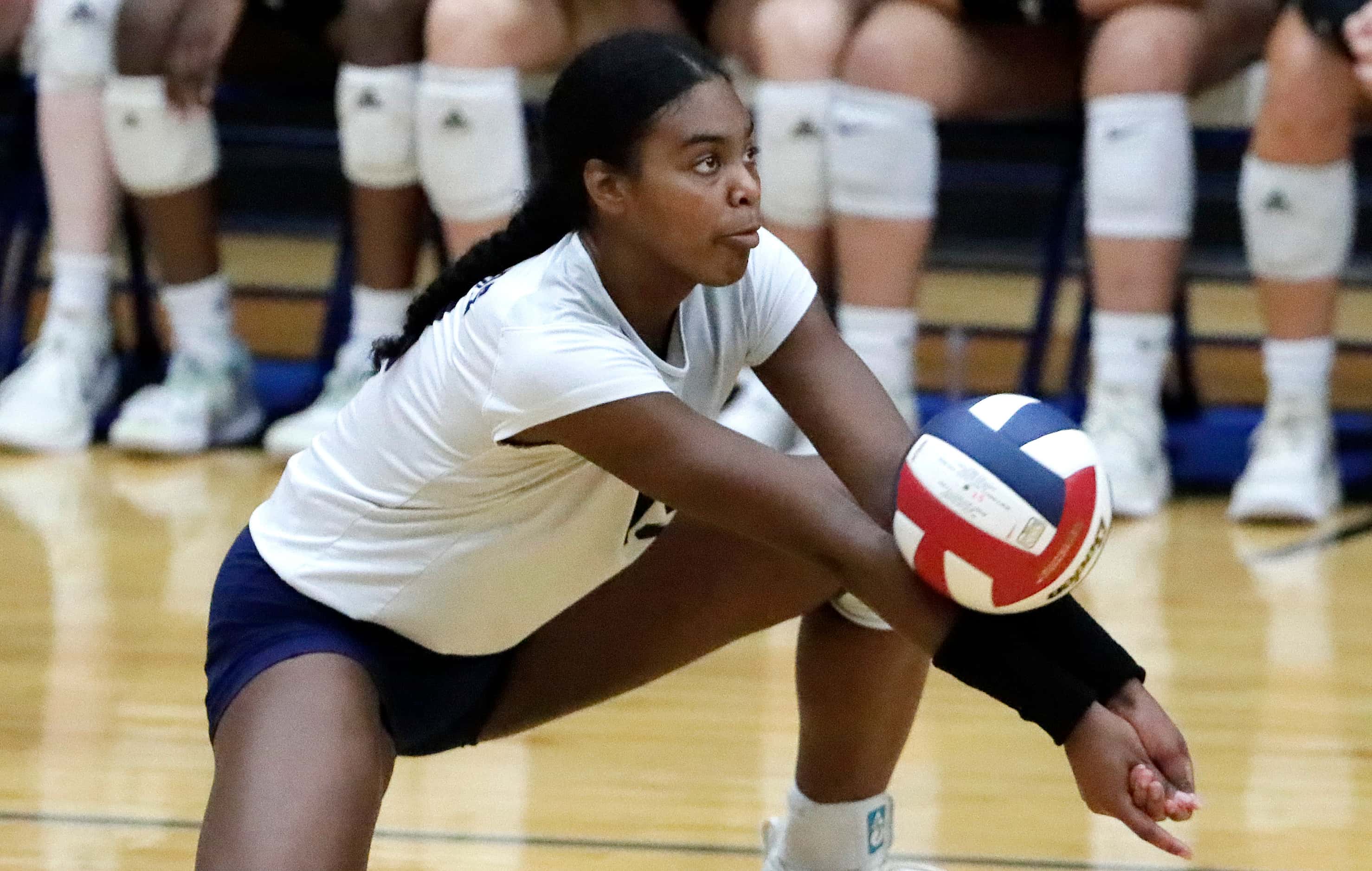 Flower Mound High School outside hitter Brianna Watson (13) receives a serve during game one...