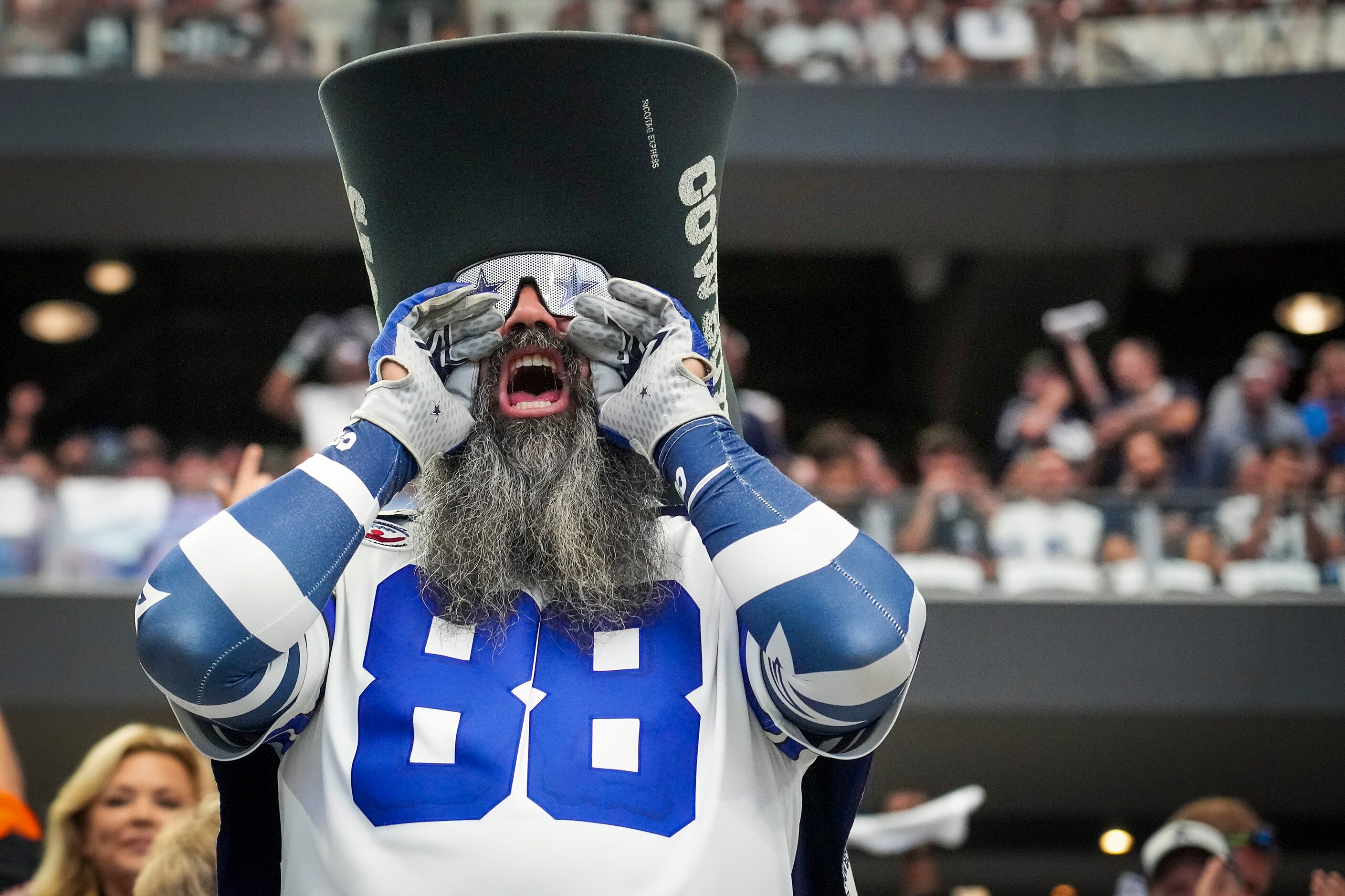 Dallas Cowboys fans cheer their team during the first half of an NFL football game against...