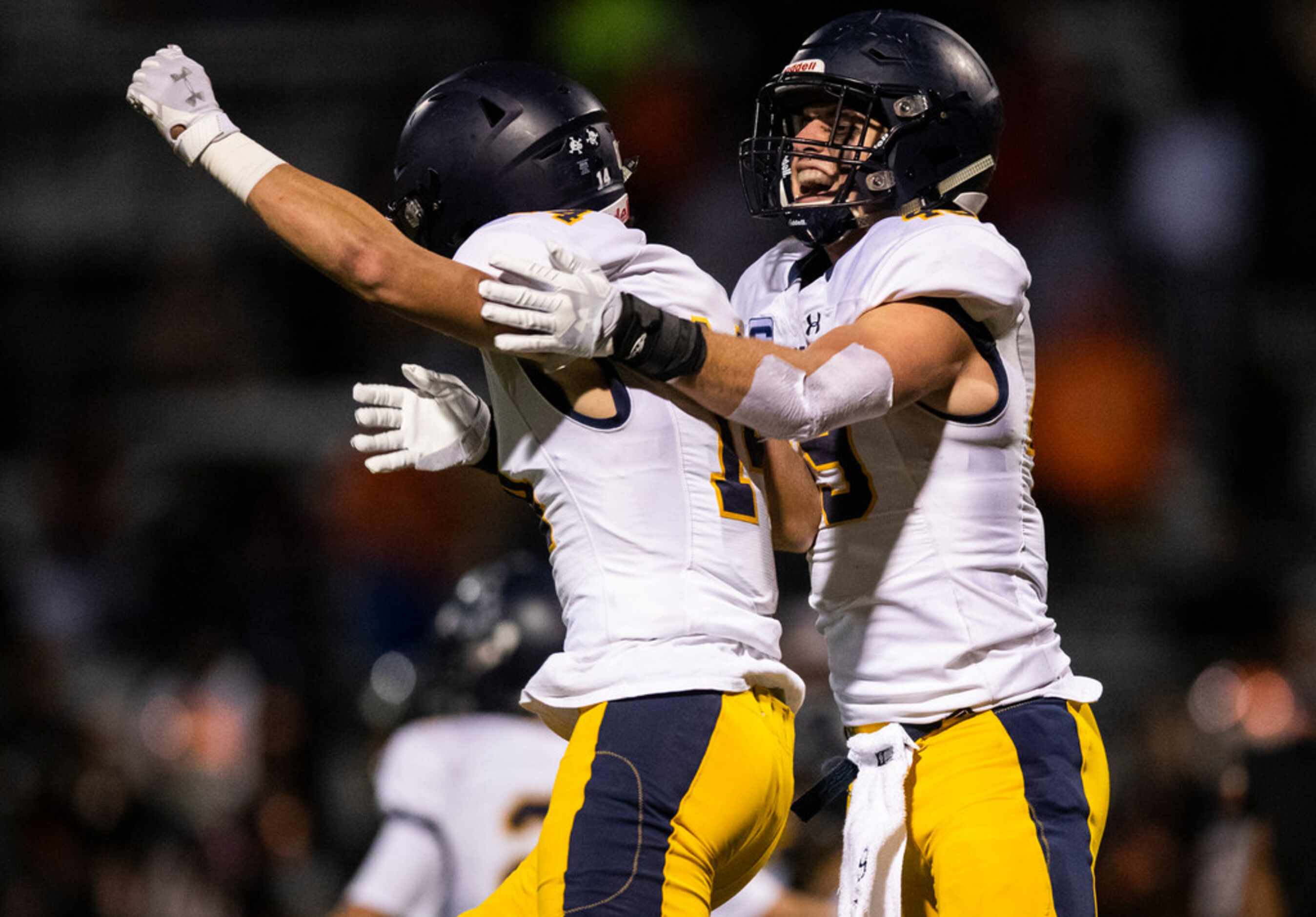 Highland Park's Christian Wright (14) and Cal Hirschey (49) celebrate a 42-35 win in...