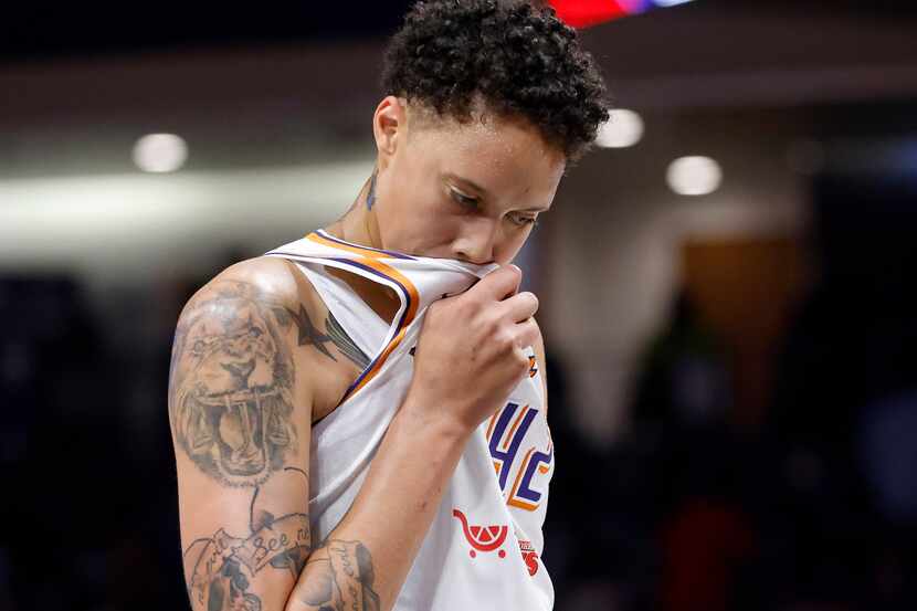 Phoenix Mercury center Brittney Griner (42) wipes away the sweat during a break in play...