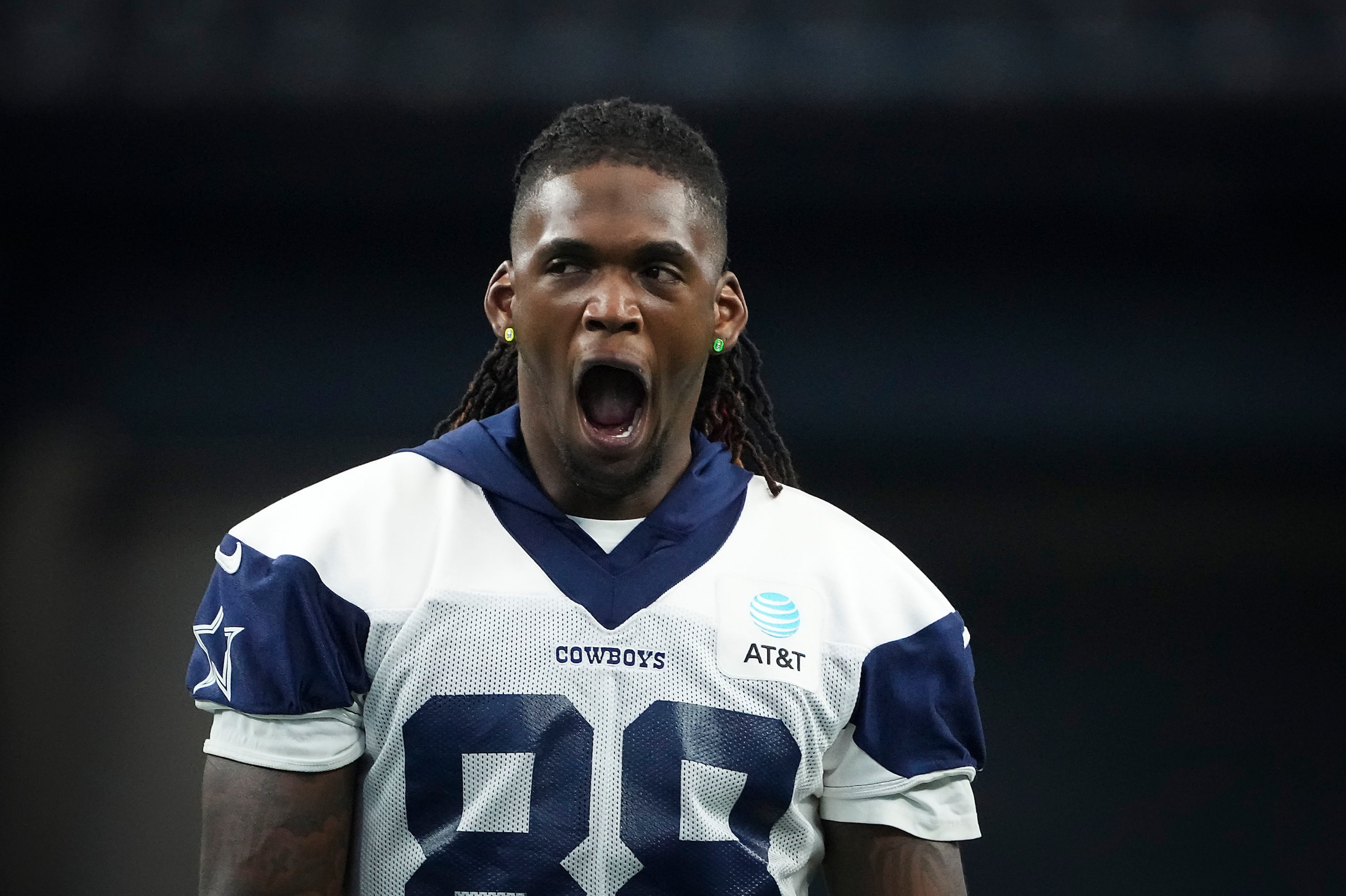 Dallas Cowboys wide receiver CeeDee Lamb yawns while warming up before an NFL preseason...