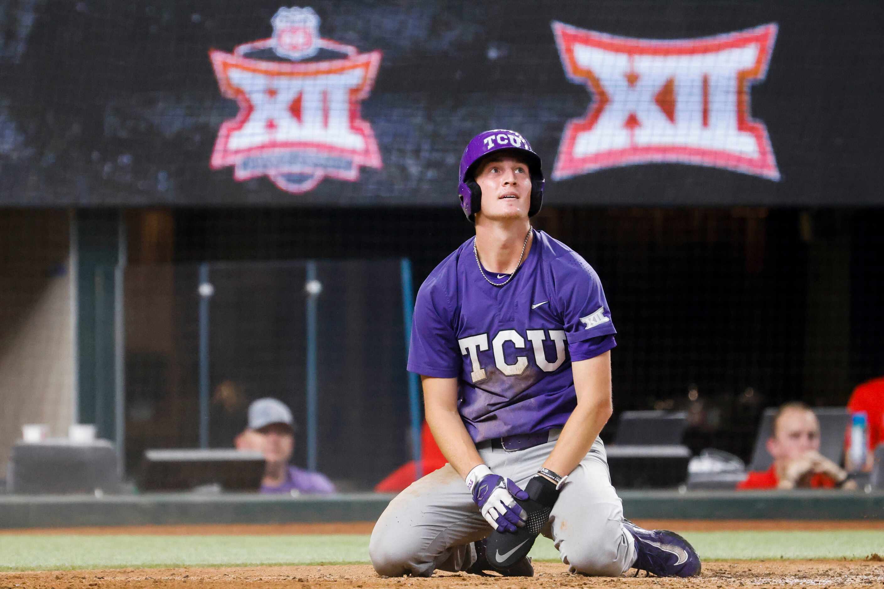 TCU infielder Cole Fontenelle watches the big screen after he was tagged out during the...