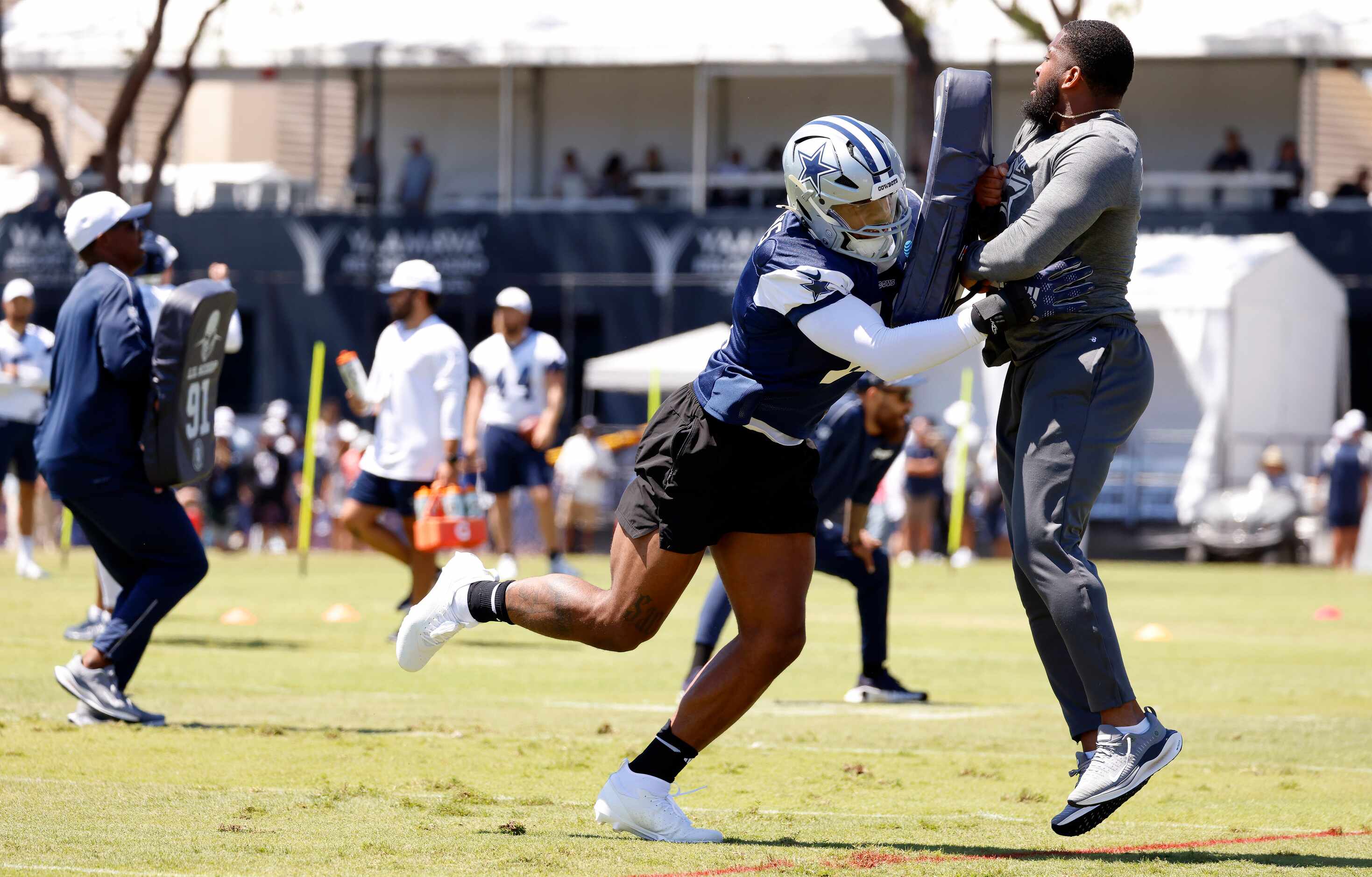 Dallas Cowboys linebacker Micah Parsons (11) launches a coach as the defense worked on...