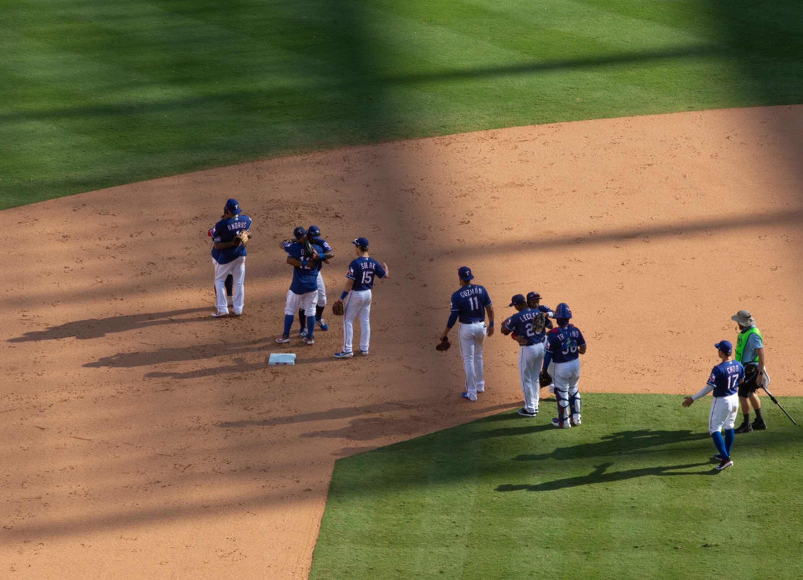 Players embrace following the Texas Rangers' final game ever played at Globe Life Park in...