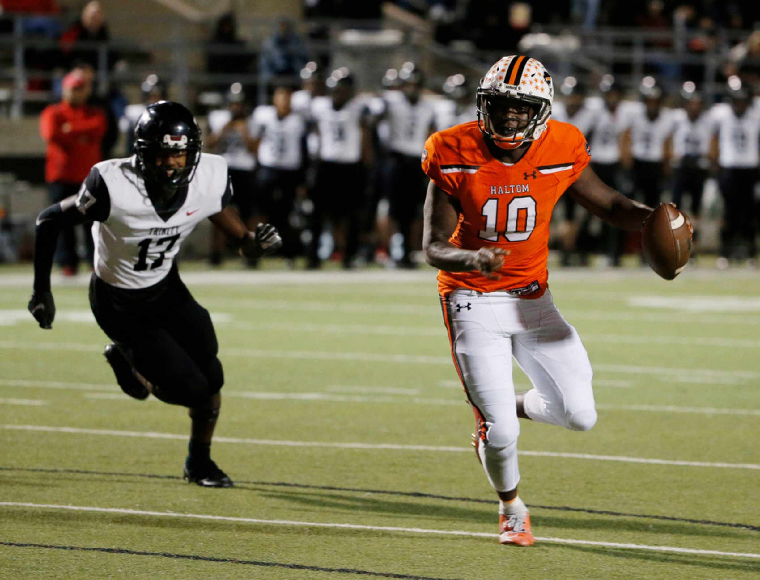 Haltom quarterback quarterback Adam Hill gets away from Trinity defender LD Martin (17) to...