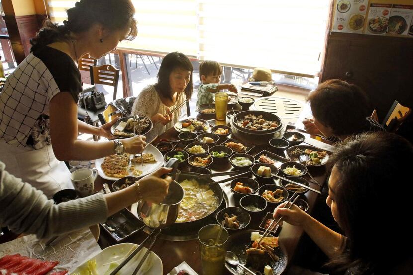 
Cheryl Collett (second from left) and her friends enjoy Shabu Shabu at Ssam Korean Grill in...