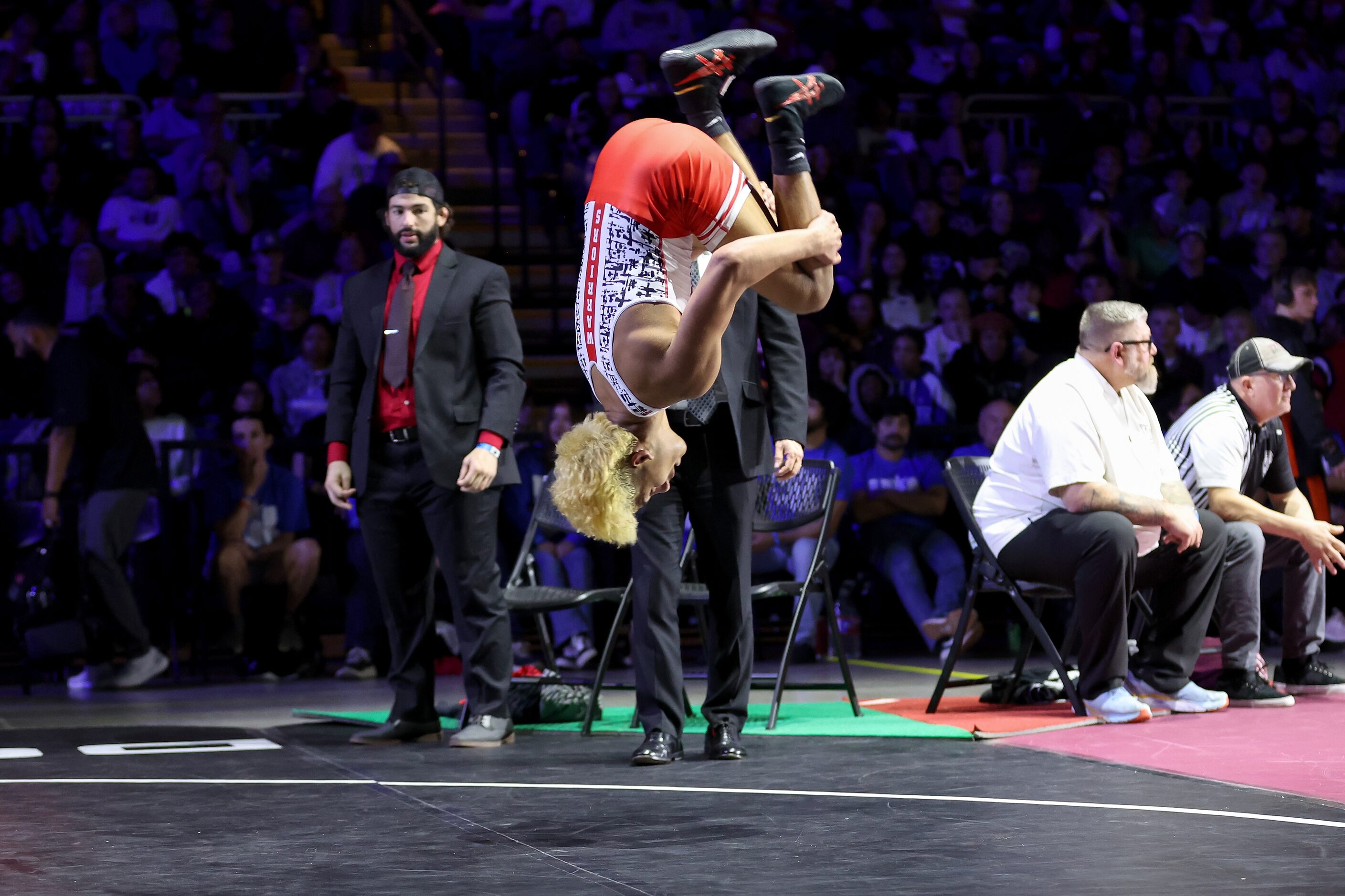 Isaak Arevalo (red) of Arlington Martin celebrates after defeating Jonah Arellano of Austin...