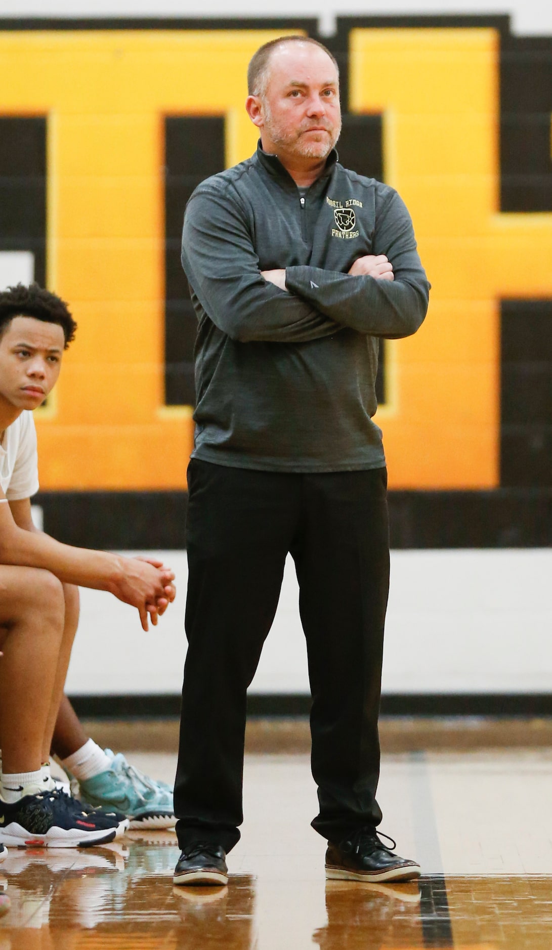 Fossil Ridge High School head coach Zack Myers watches the clock during the fourth quarter...