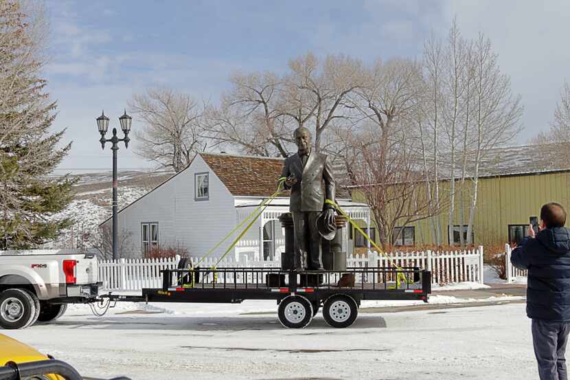 James Cash Penney statue on a trailer drives past the home where Penney lived when he opened...