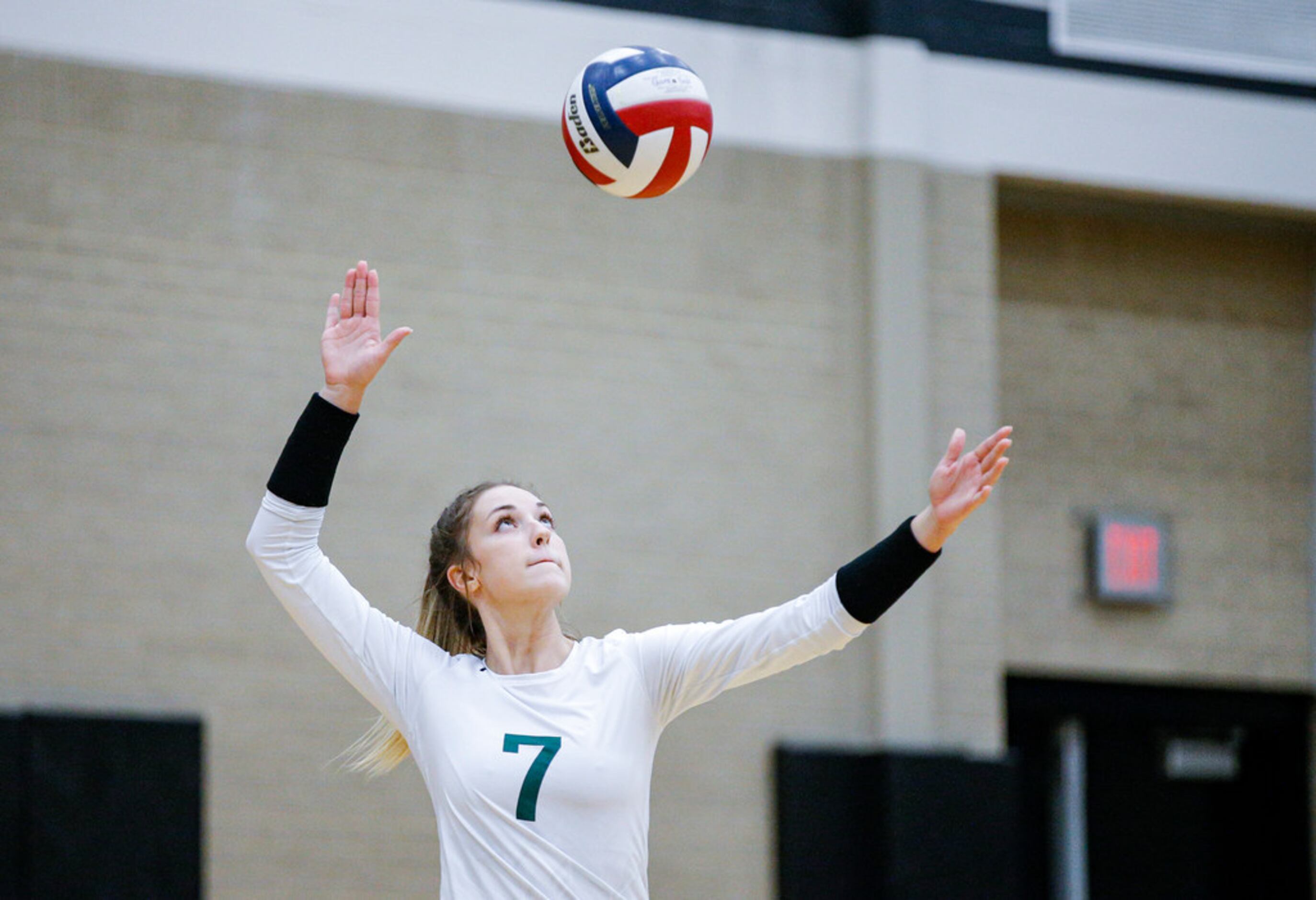 Mansfield Lake Ridge senior Logyn Hinds (7) serves during a high school volleyball game...