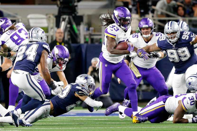 Minnesota Vikings running back Dalvin Cook (33) finds a hole in the Dallas Cowboys defines...