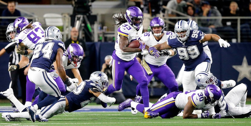 Minnesota Vikings running back Dalvin Cook (33) finds a hole in the Dallas Cowboys defines...