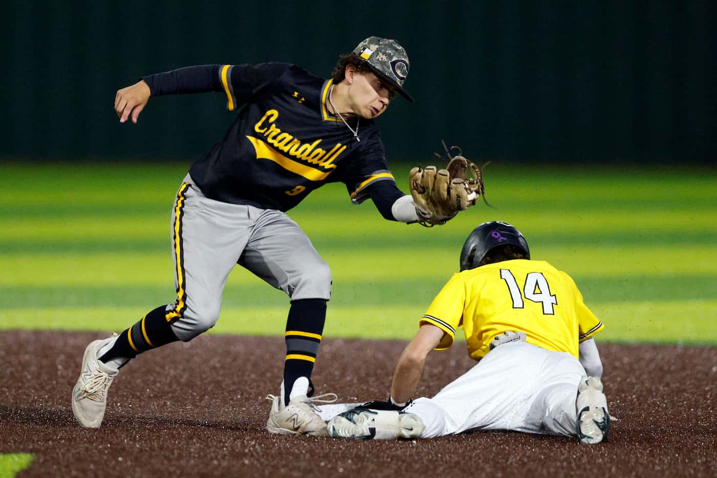 Forney shortstop Dylan Clark (14) steals second base ahead of the tag from Crandall...