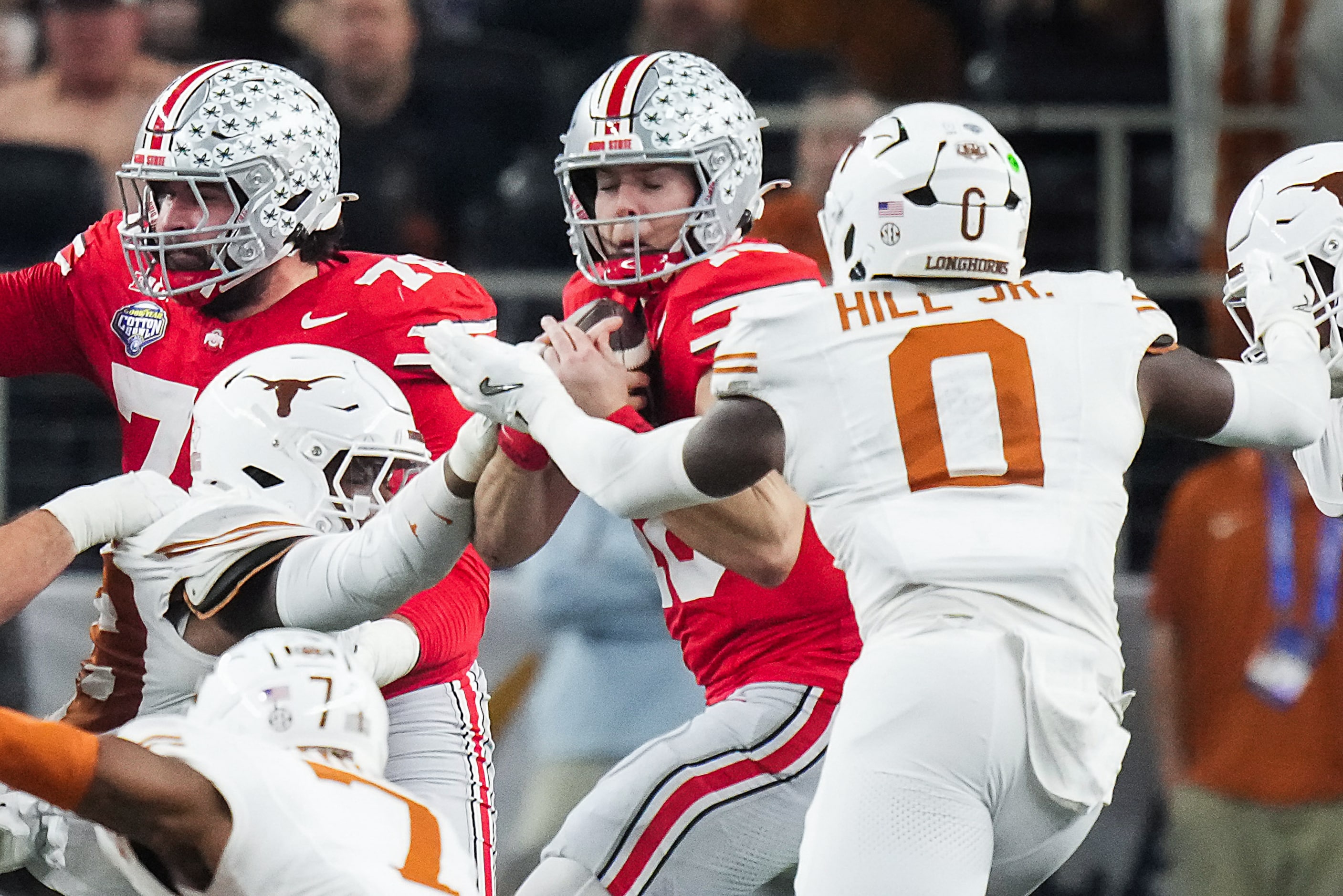 Ohio State quarterback Will Howard (18) is sacked by Texas linebacker Anthony Hill Jr. (0)...