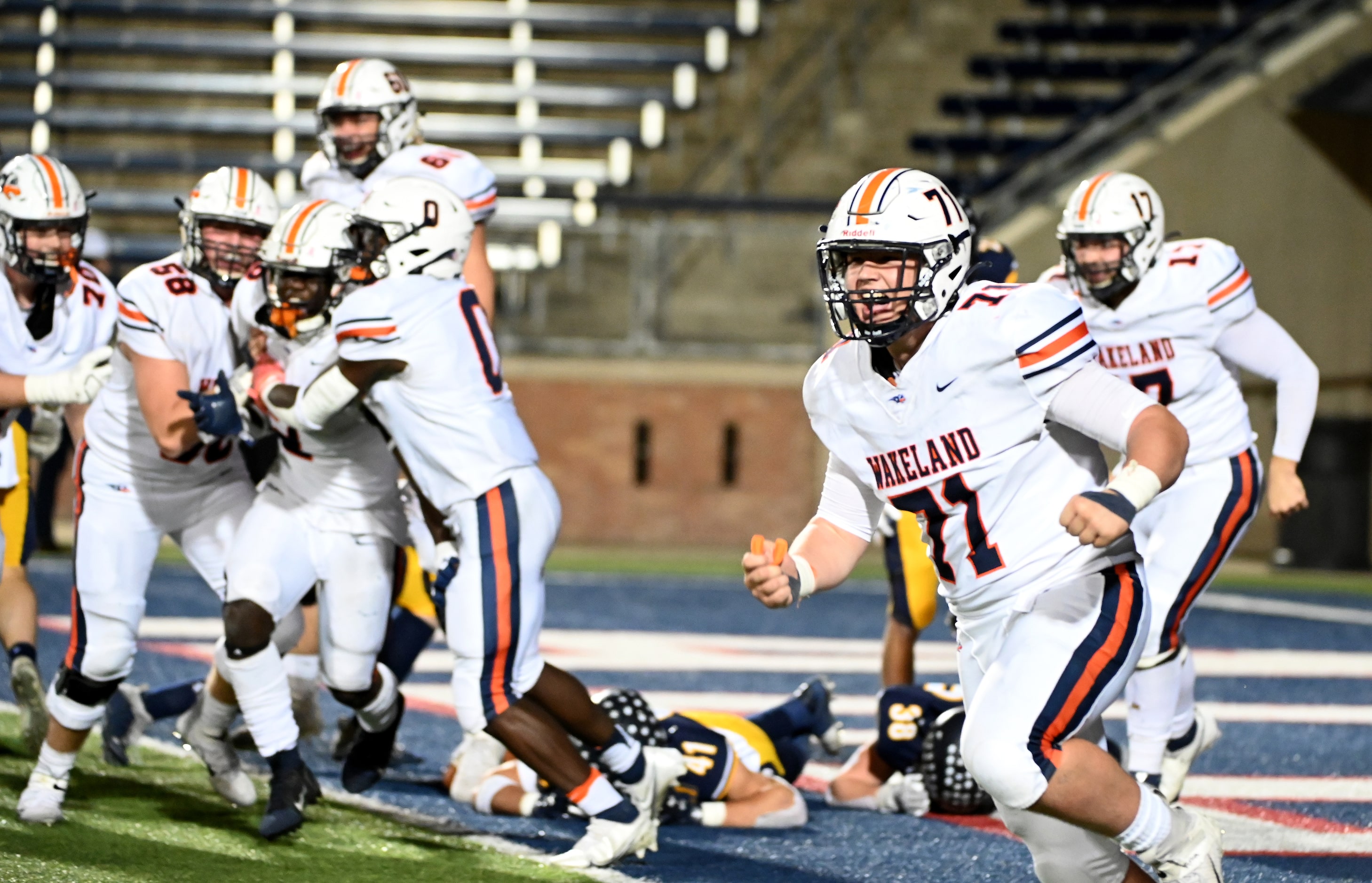 Wakeland's Will Hickman (71) runs off the field as Wakeland players celebrate their...