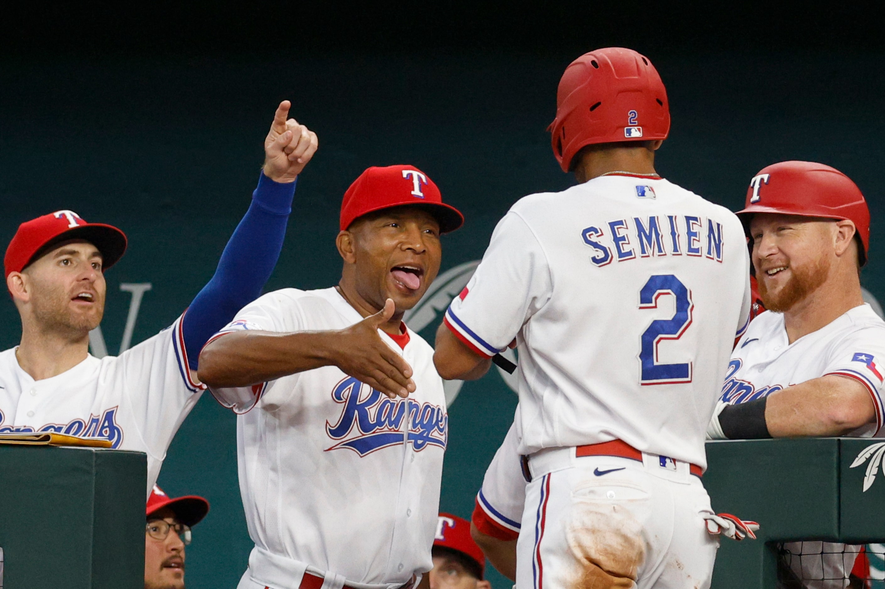 Texas Rangers interim manager Tony Beasley (27) celebrates a two-run home run with Texas...