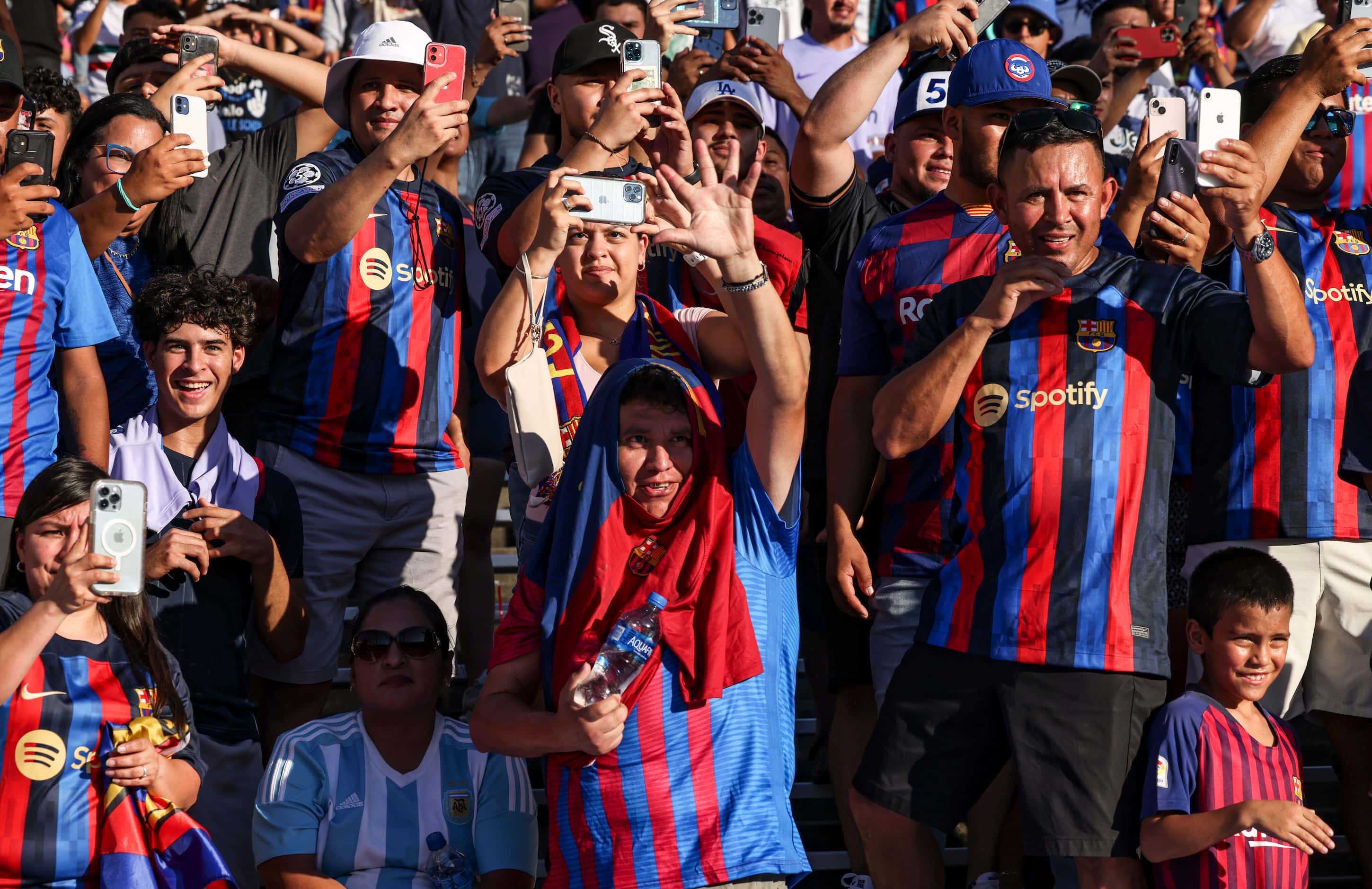 Barcelona fans cheer as team members walk past them, Tuesday, July 26, 2022 at Cotton Bowl...