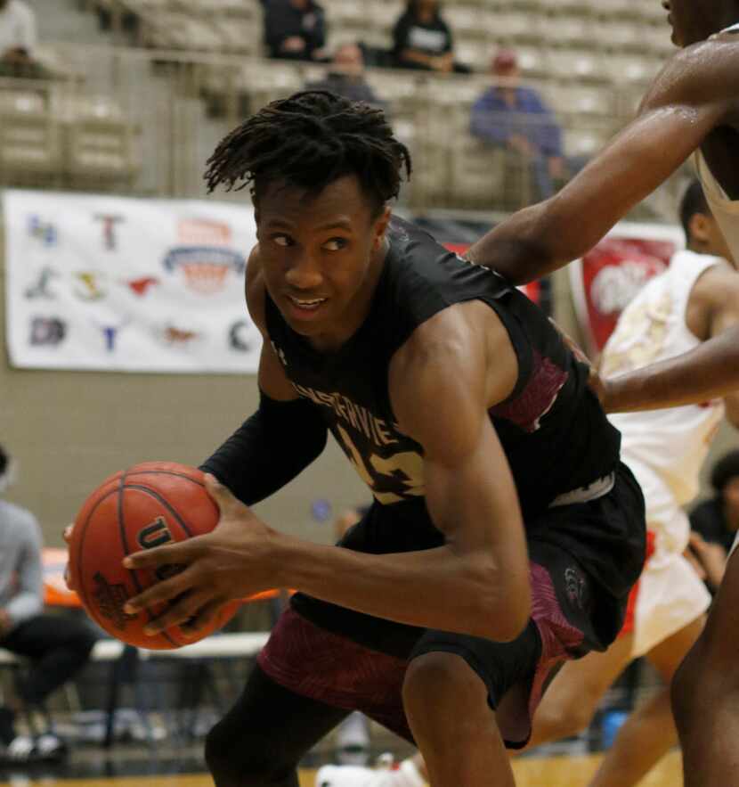 Mansfield Timberview guard Trazarien White (23) looks for an escape route after pulling down...