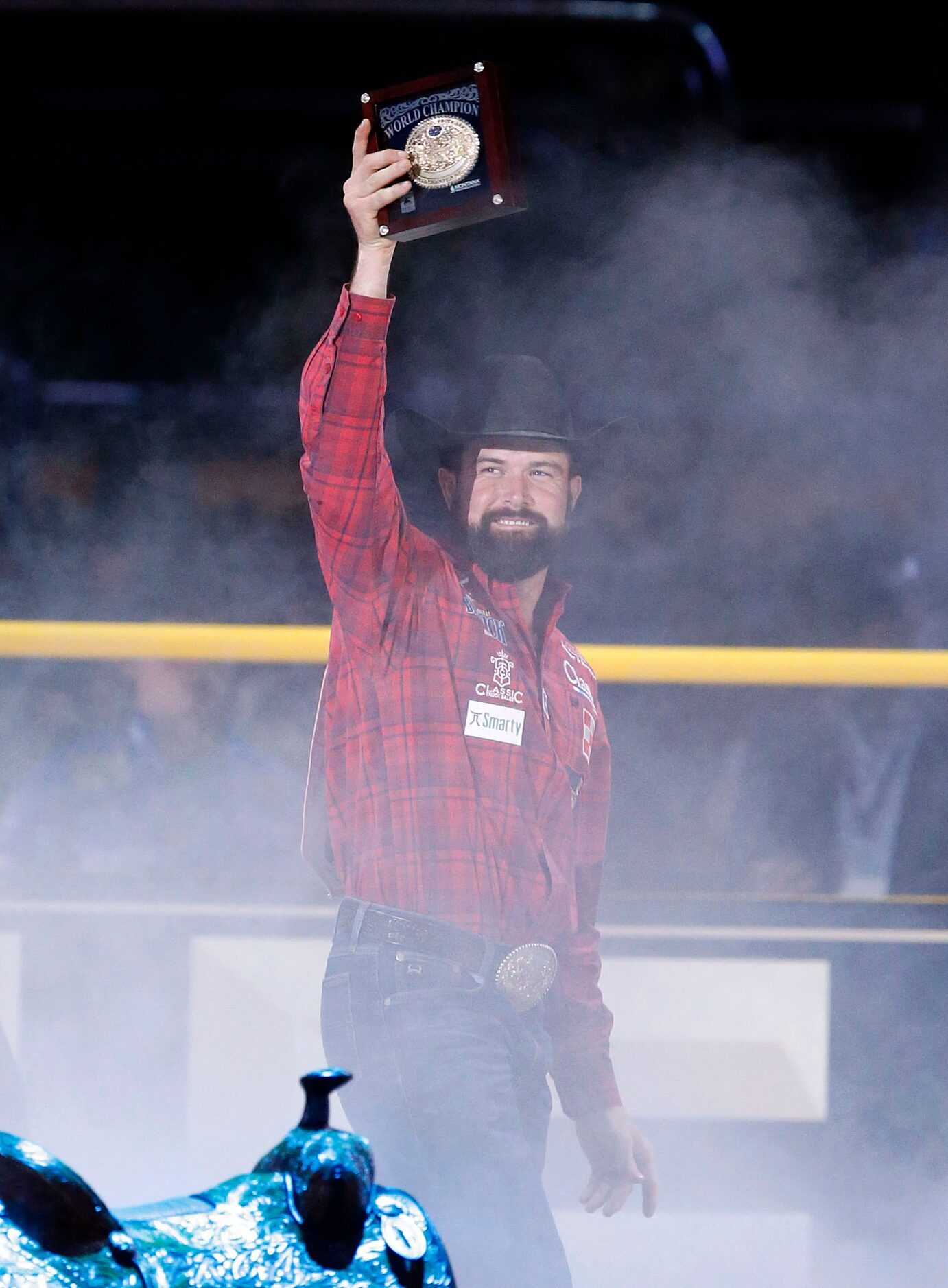 Team Roping Heeler World Champion Paul Eaves of Lonedell, Missouri raises his winning belt...