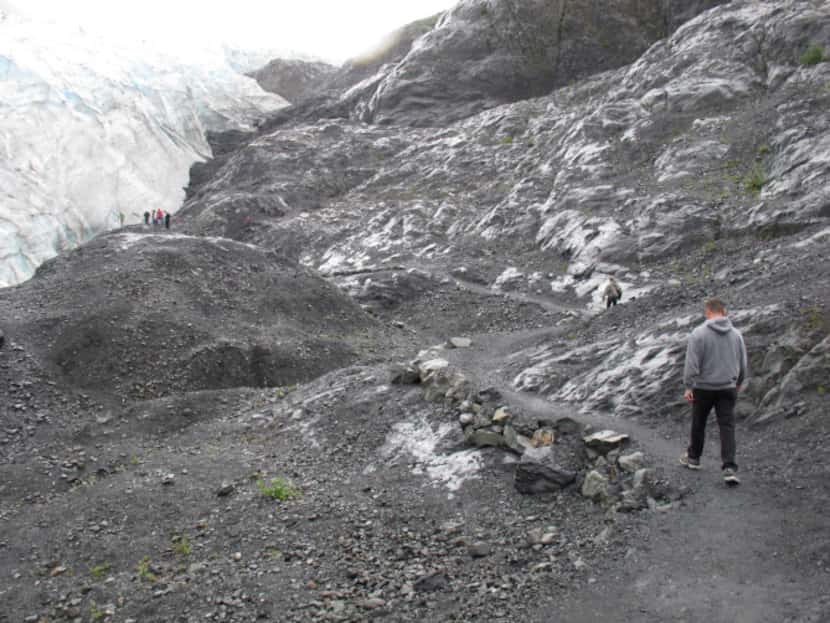This photo taken Aug. 4, 2012, shows tourists walking to Exit Glacier in Kenai Fjords...