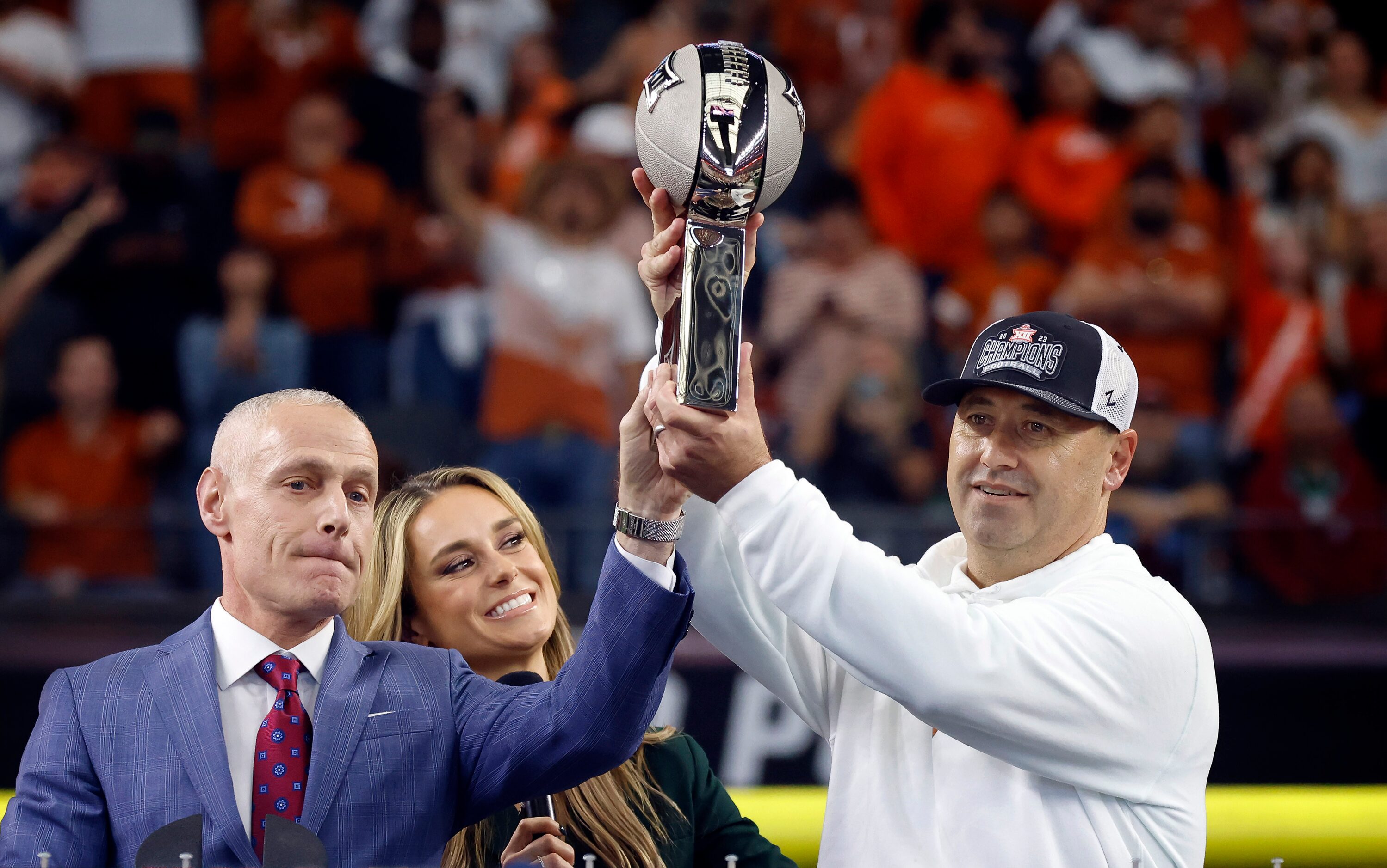 Big 12 Commissioner Brett Yormark (left) presents Texas Longhorns head coach Steve Sarkisian...