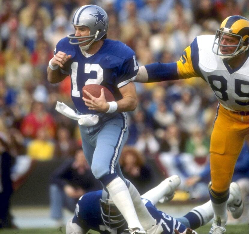 Cowboys quarterback Roger Staubach scrambles from the pocket during a playoff game against...