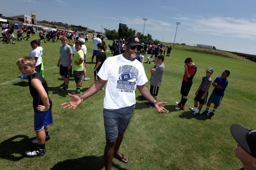 Ex-Cowboys football player Michael Irvin coaches the kids during the Michael Irvin youth...
