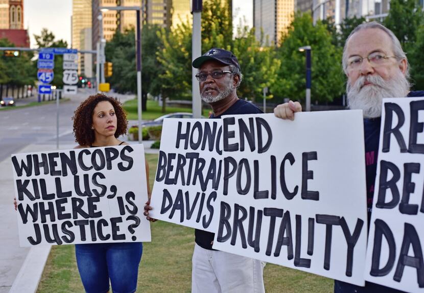 Sara Mokuria, co-founder of Mothers Against Police Brutality, holds a sign during an August...