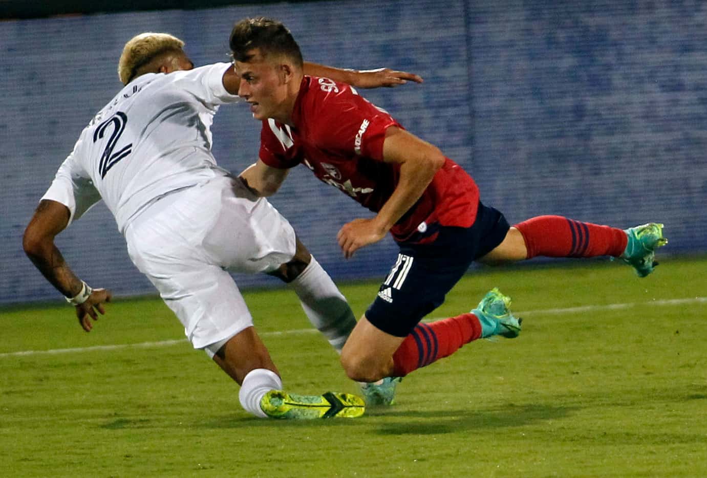 FC Dallas midfielder Szabolcs Schon (11), right, gets tangled with LA Galaxy defenseman...