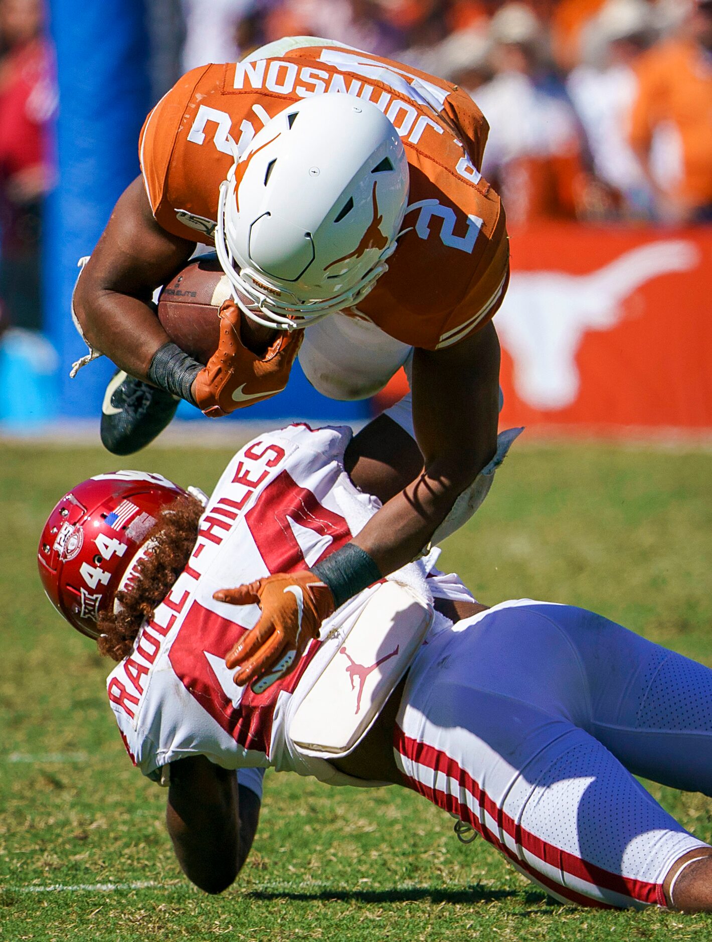 Texas quarterback Roschon Johnson (2) is upended by Oklahoma defensive back Brendan...