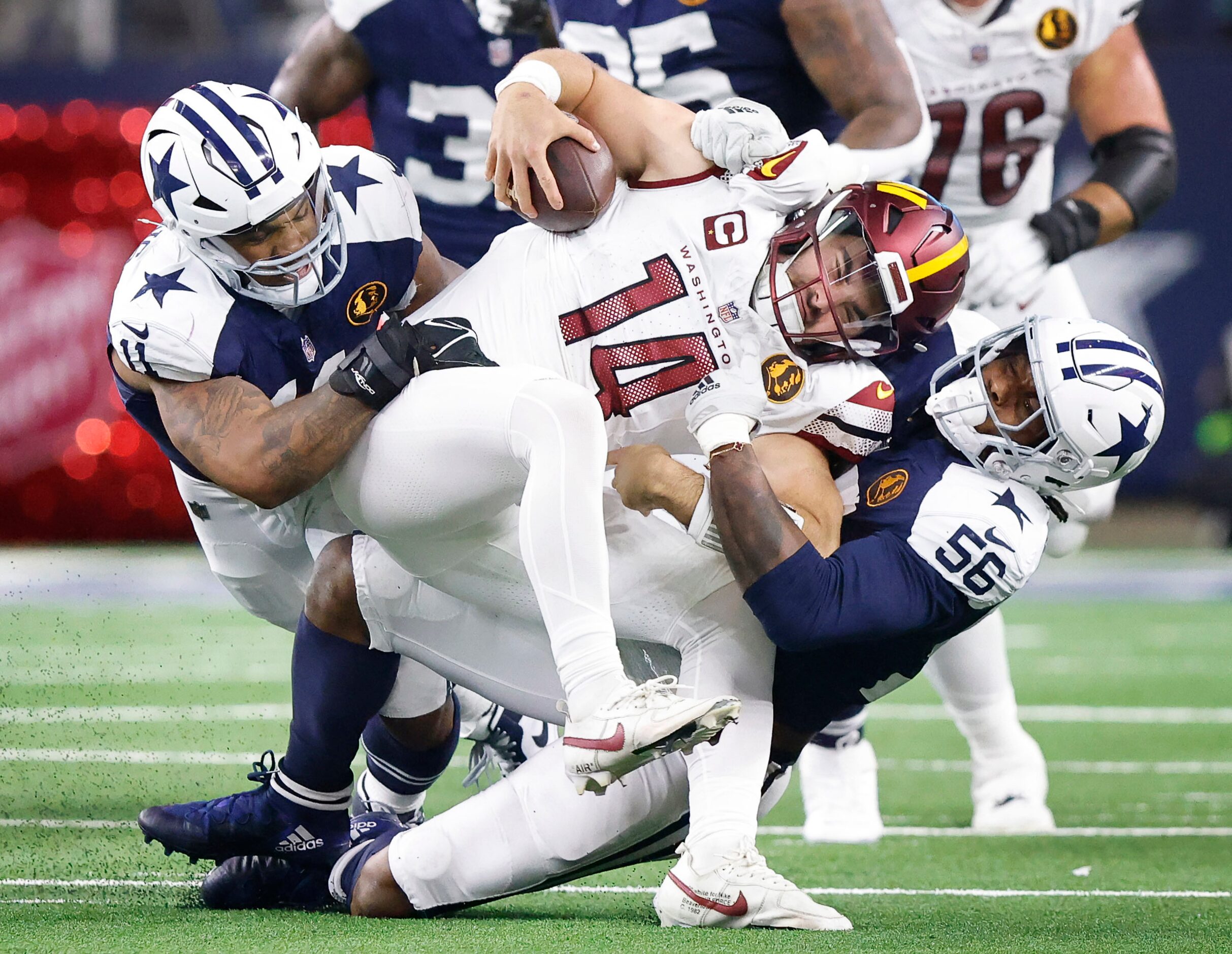 Dallas Cowboys linebacker Micah Parsons (11) and  defensive end Dante Fowler Jr. (56) sack...