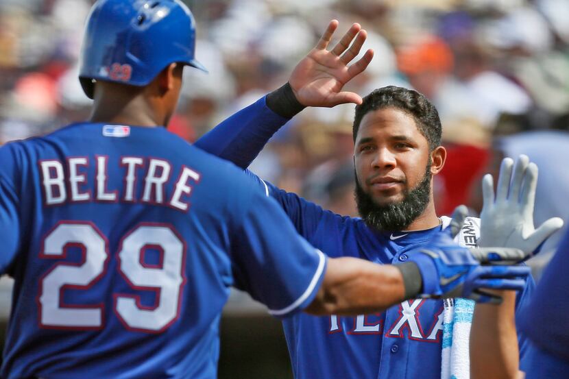 Texas shortstop Elvis Andrus, right, congratulates teammate Adrian Beltre after he scored a...
