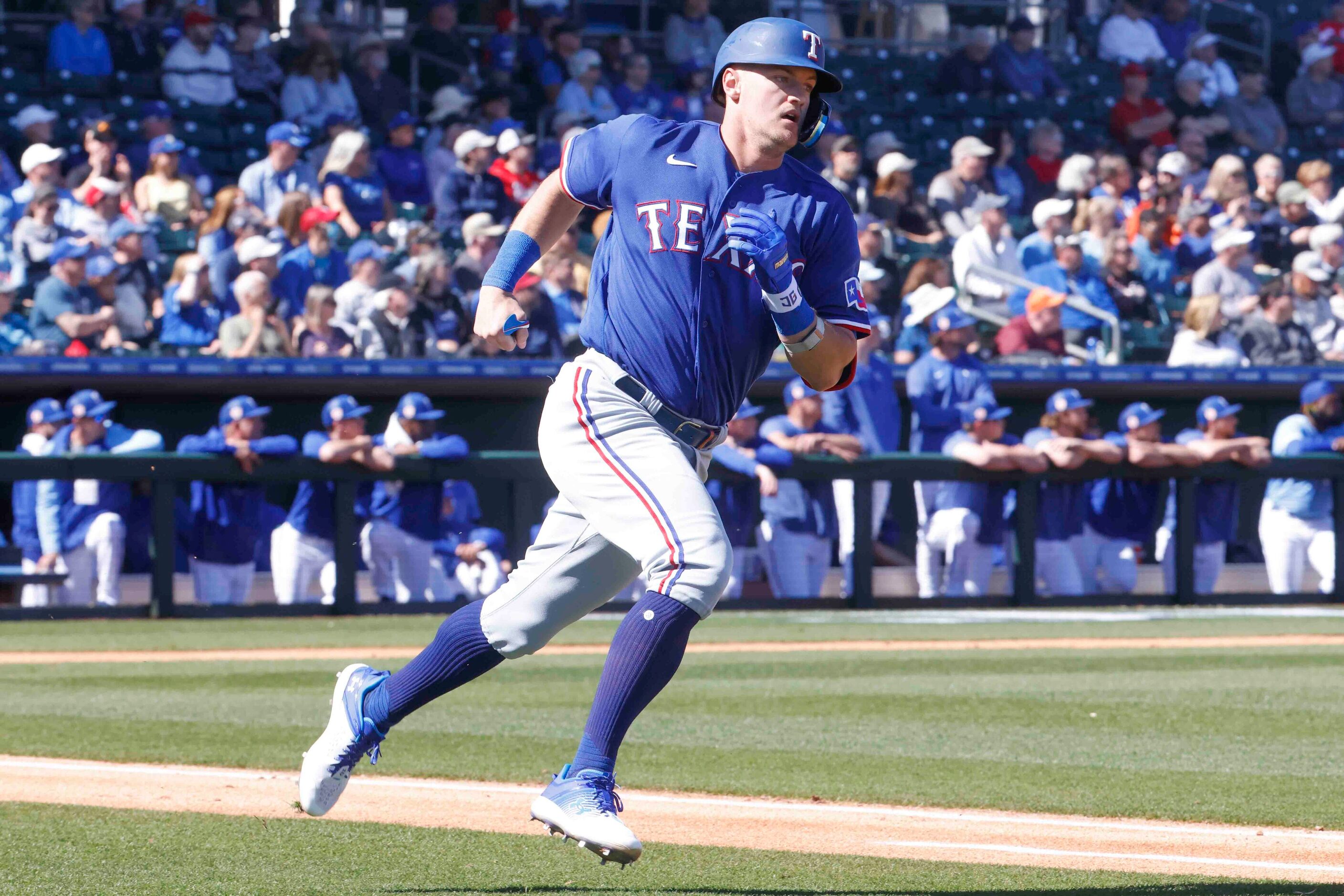 Texas Rangers Josh Jung runs between bases during the second inning of a spring training...