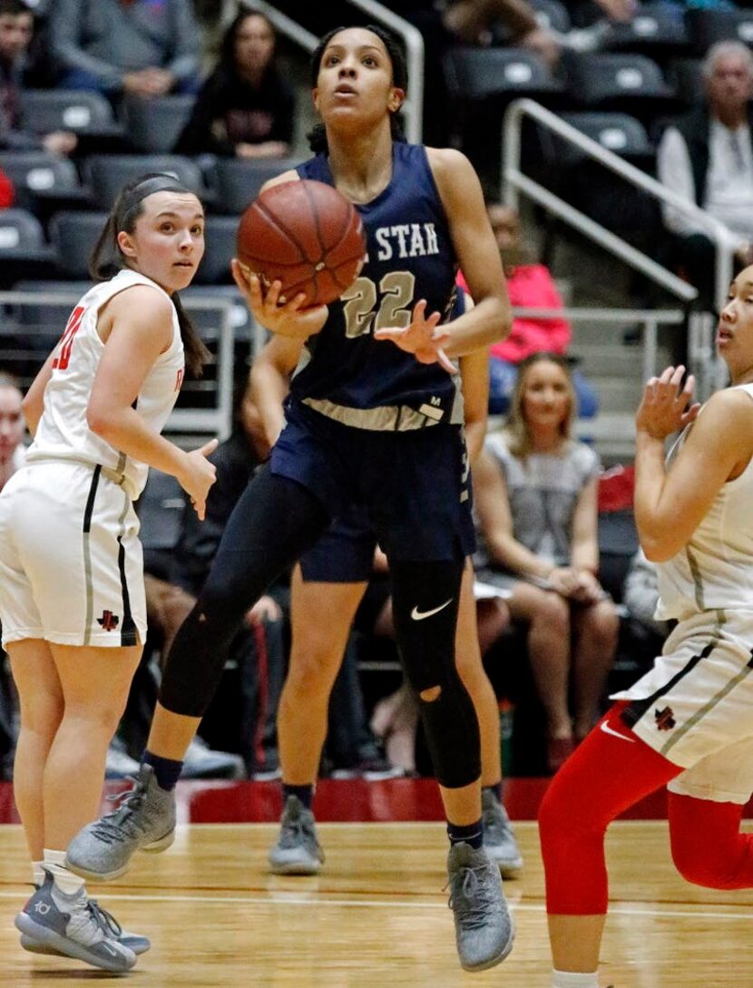 Lone Star High School guard Mia Deck (22) attempts a layup during the first half as Liberty...