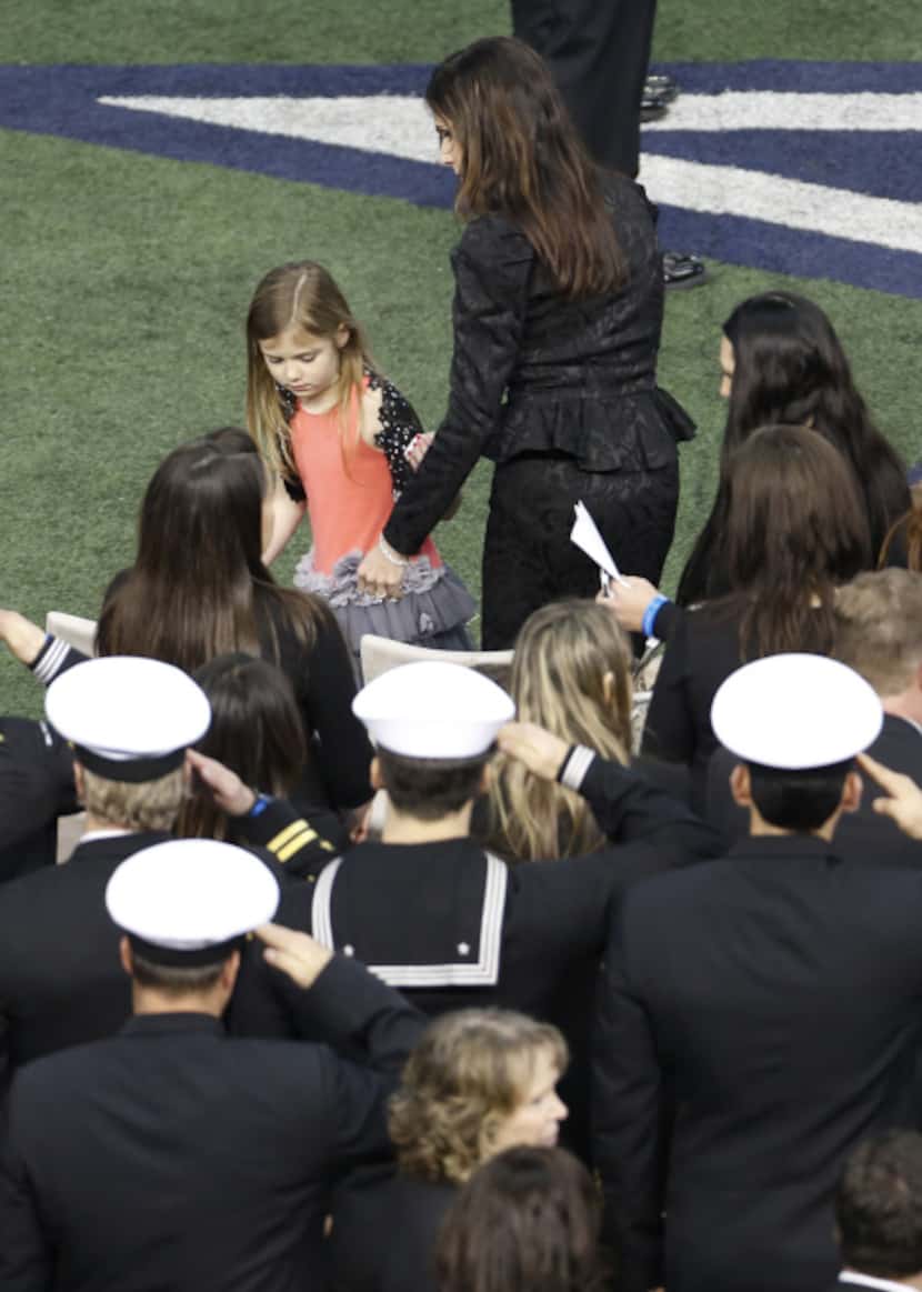 Taya Kyle, wife of former Navy SEAL Chris Kyle, helps her daughter to her seat at the...