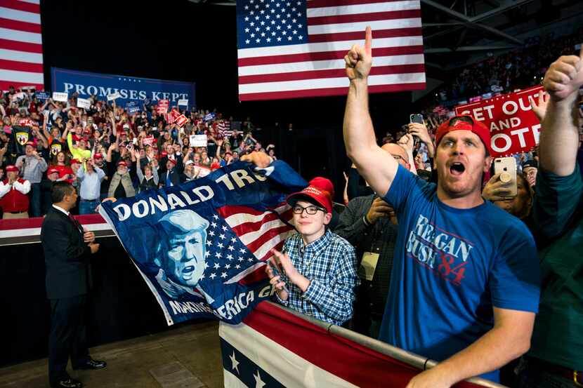 Supporters cheer as President Donald Trump speaks at a rally in Cape Girardeau, Mo., on Nov....